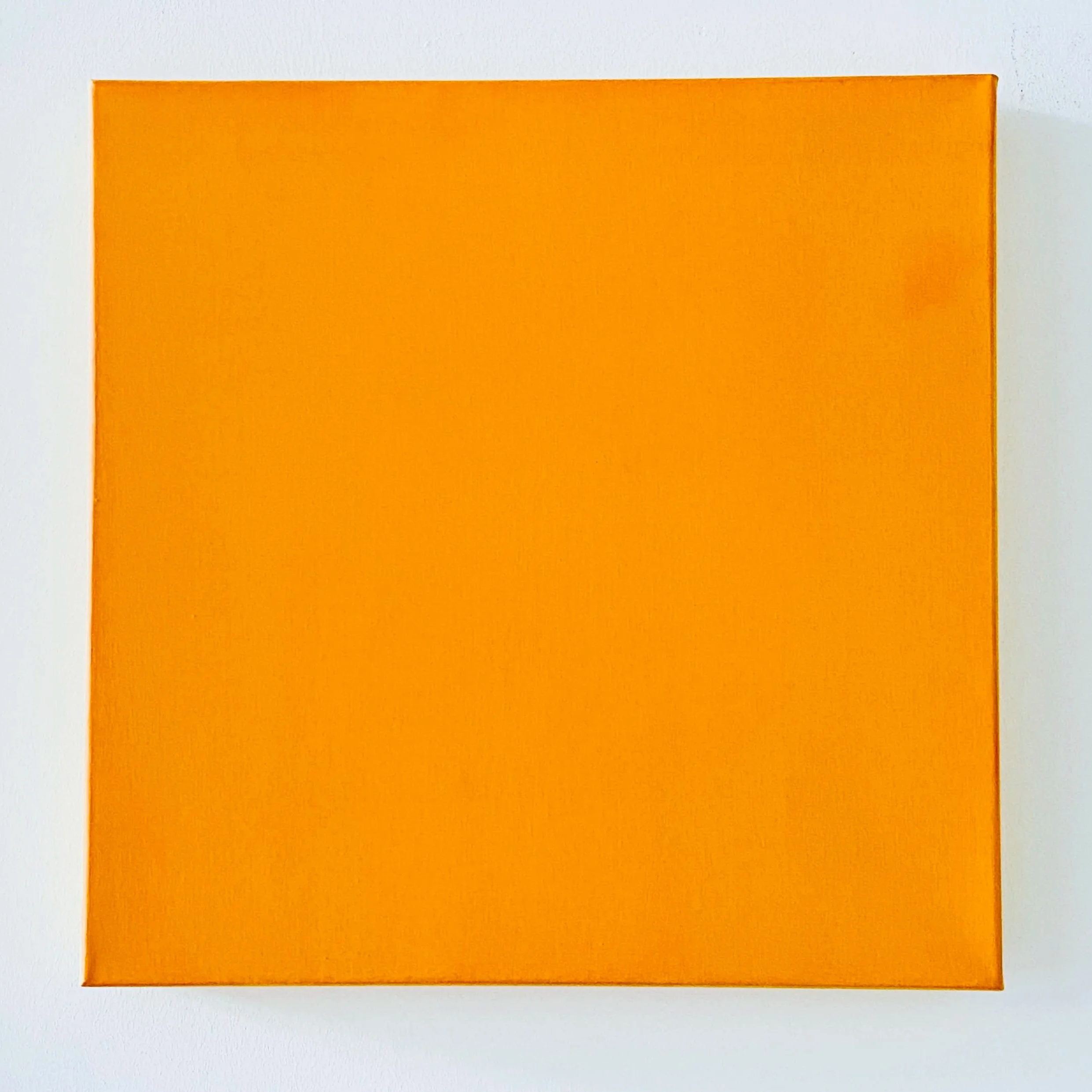 Close-up of a square orange box against a white background.