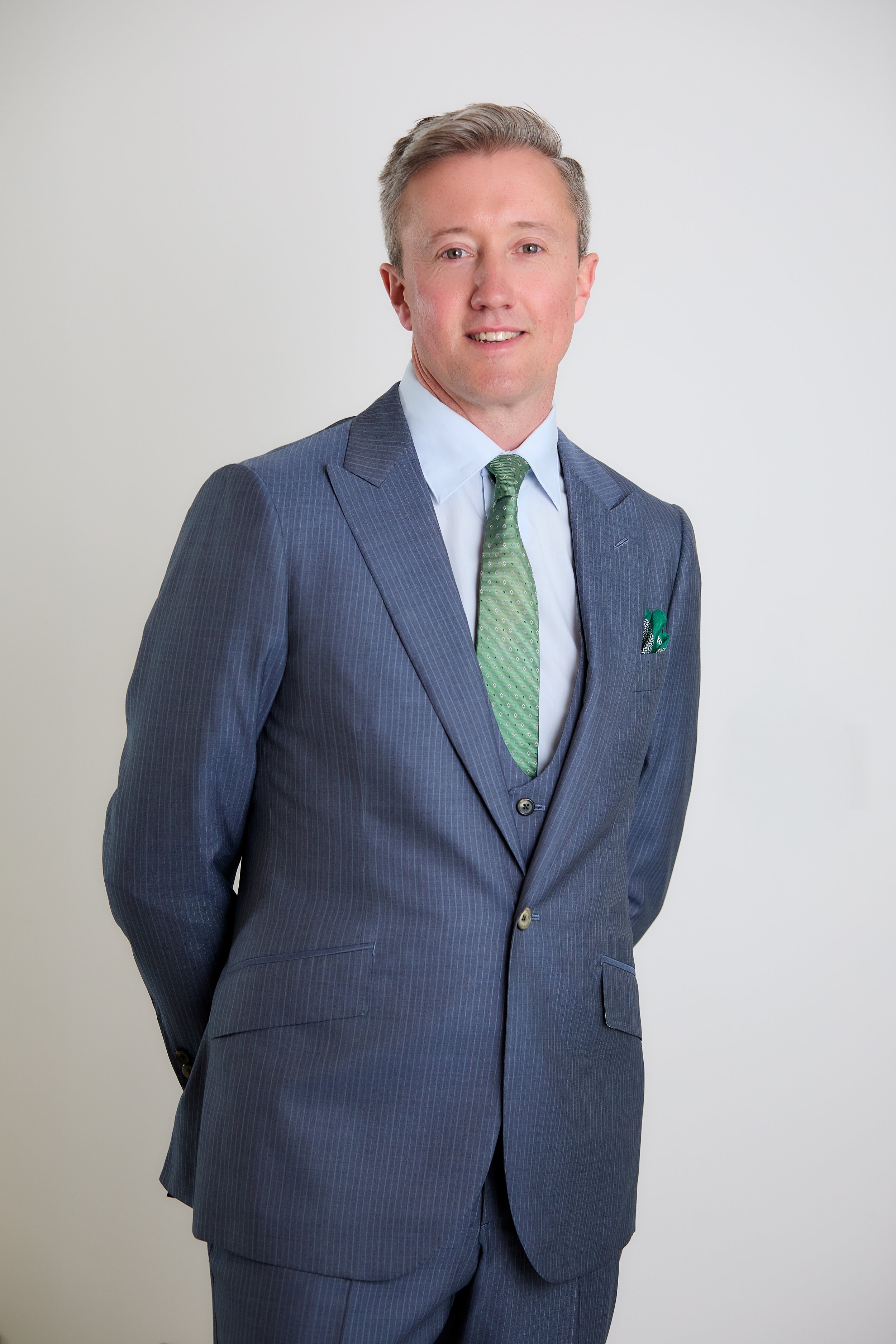 Ian Powell, lead visiting tailor at Salt Bespoke, wearing a navy stripe three piece suit and green luxury tie