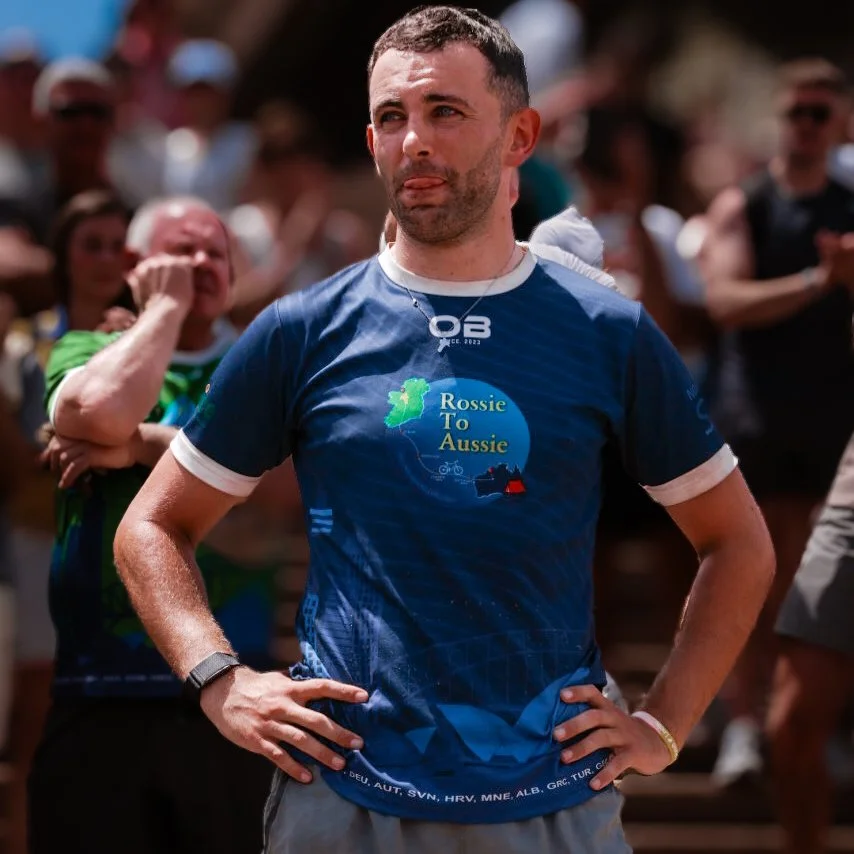A man wearing a blue T-shirt with 