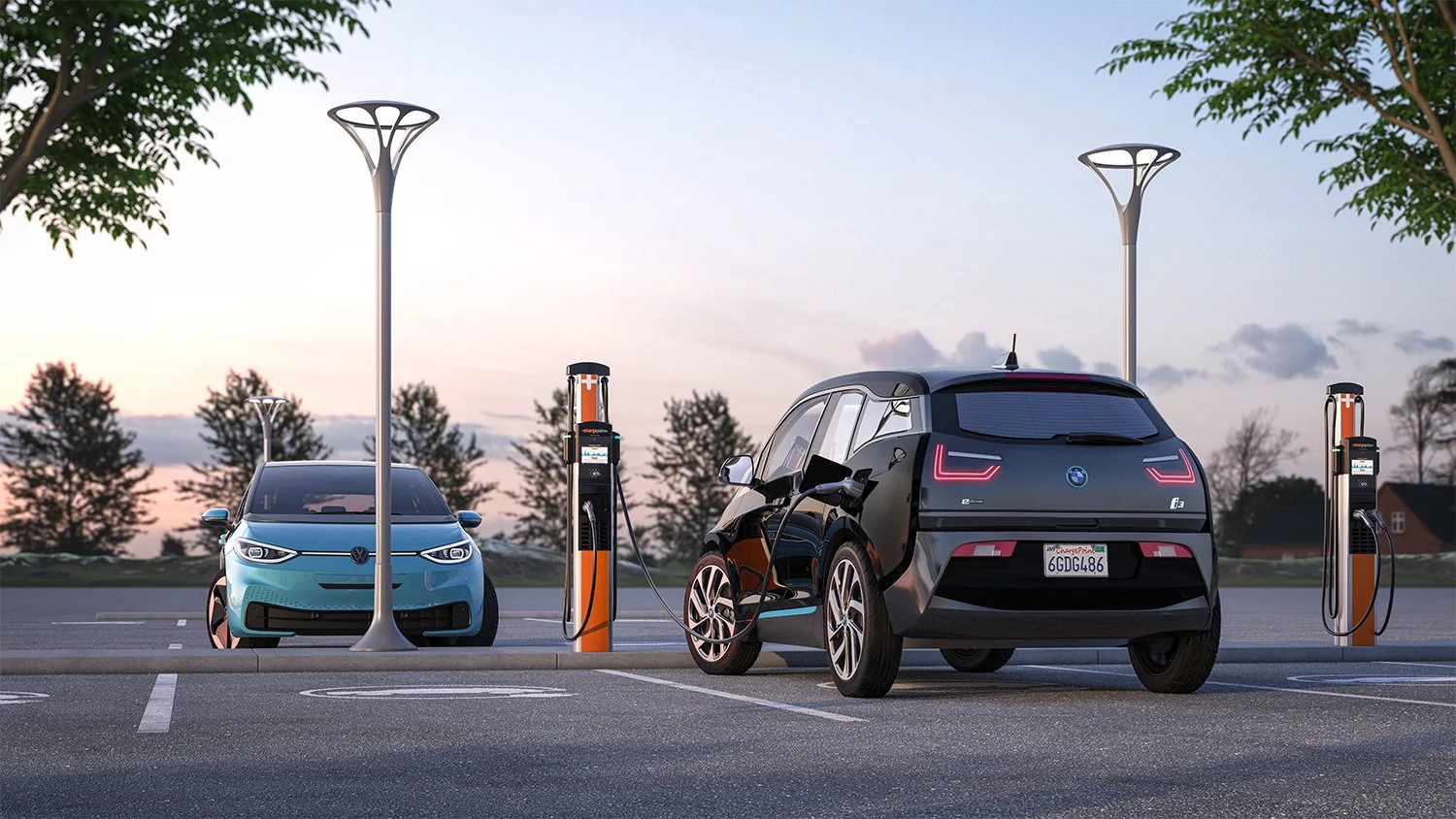 Two electric cars charging at a parking lot with charging stations, trees, and a sunset in the background.