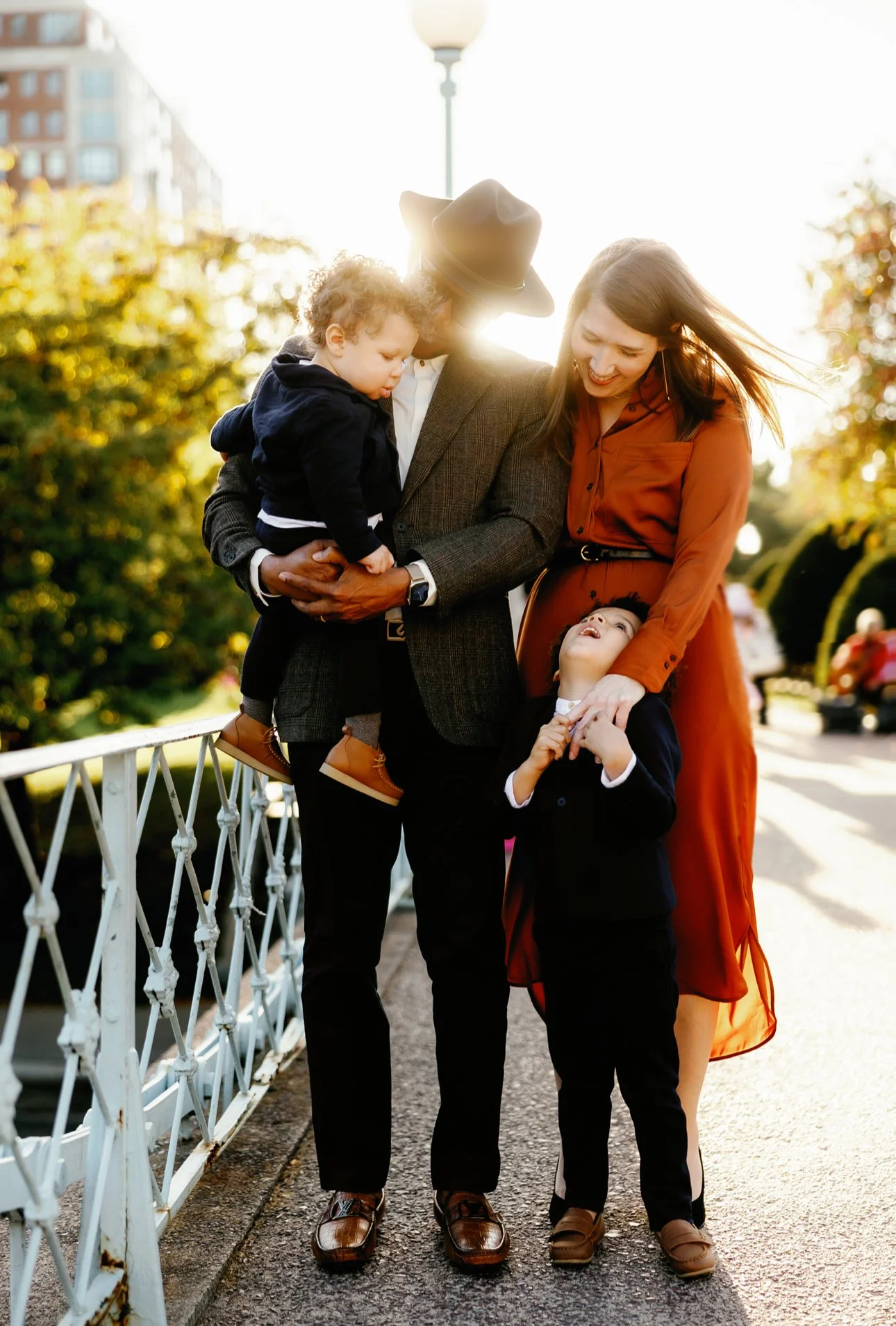 Henry Emele with his wife and two sons enjoying a sunset together.