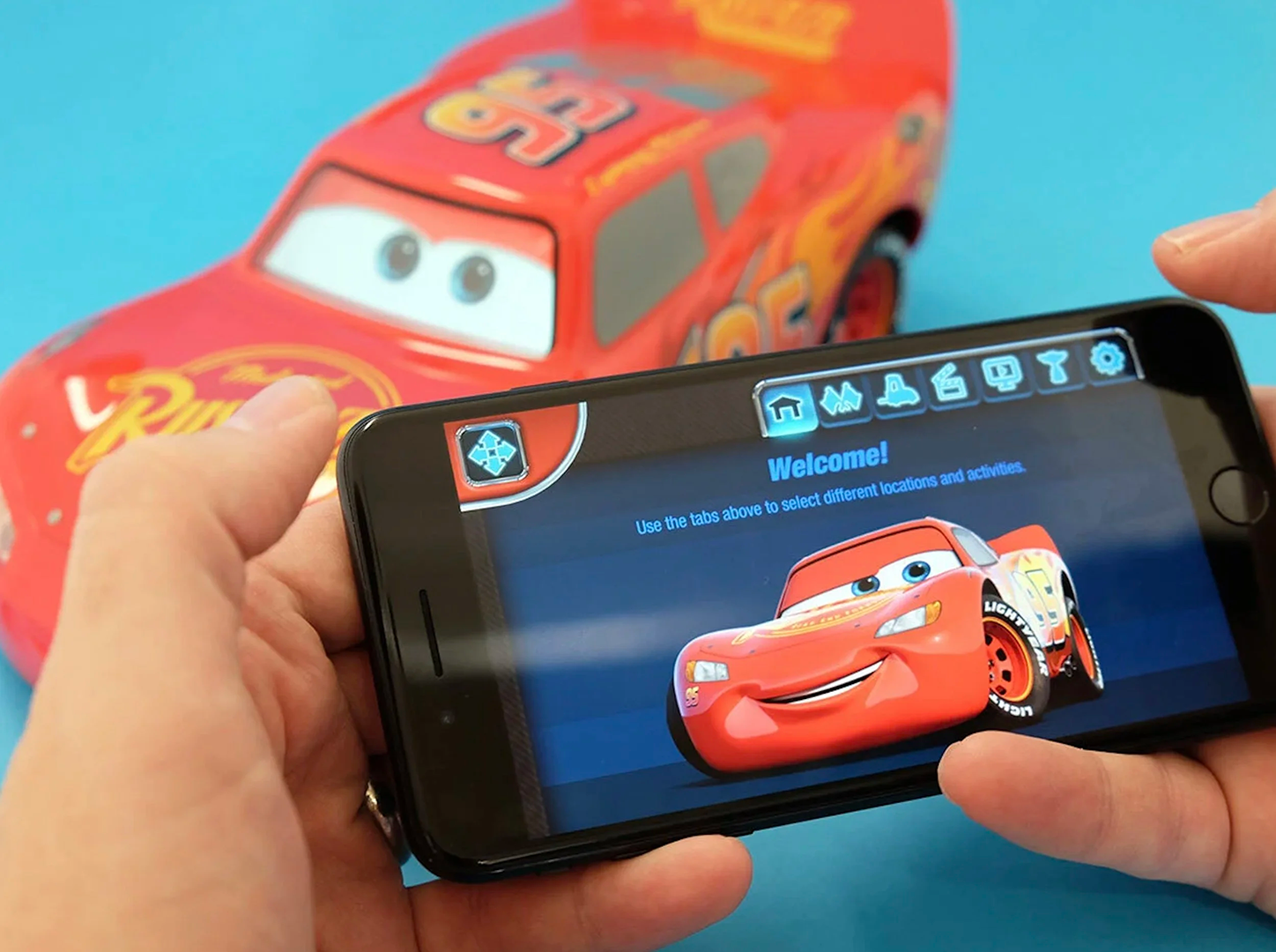 Close up image of the Lightning McQueen app with the robot in the background. App art created in Adobe and Fusion 360, for Sphero, Pixar and Disney.