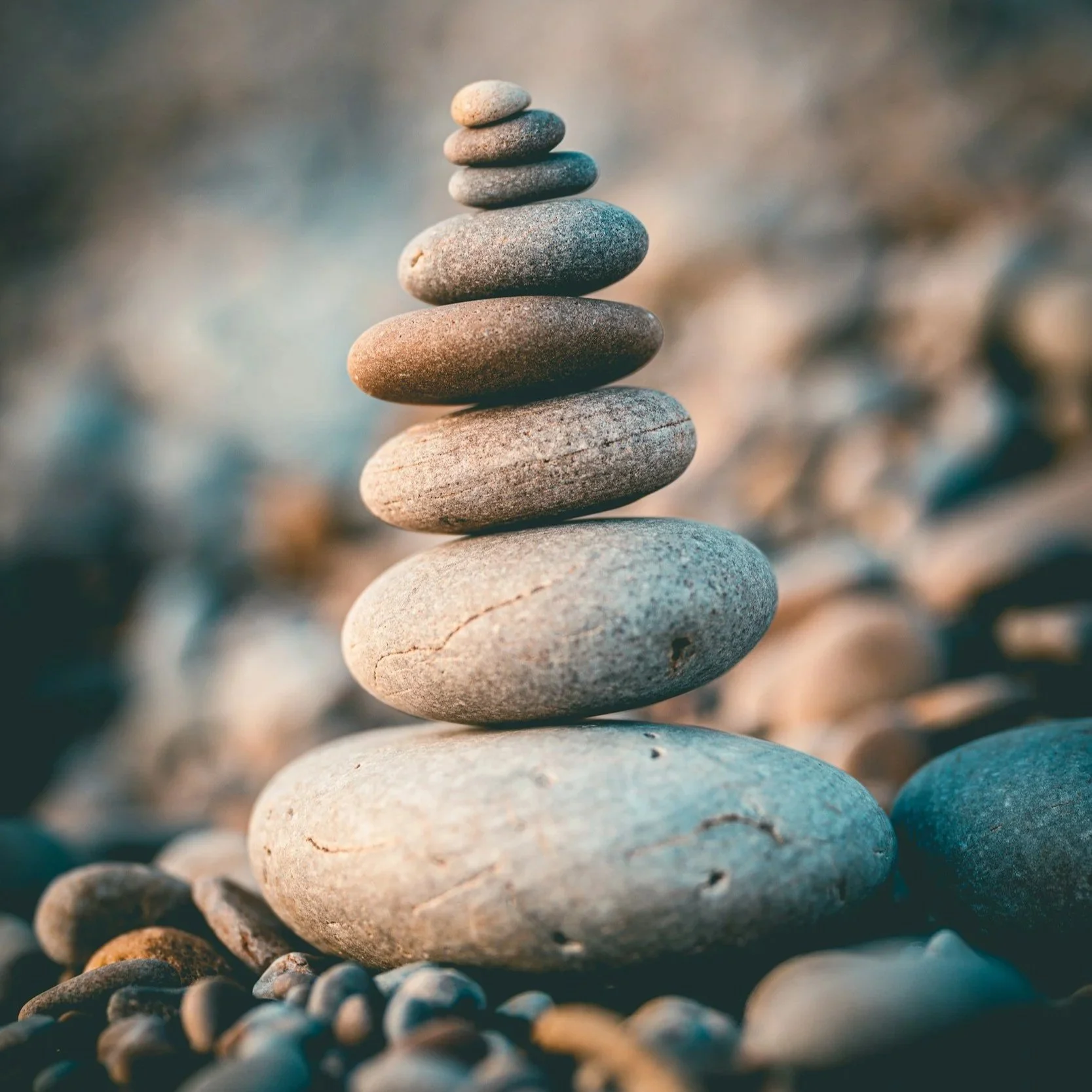Stack of smooth stones balanced on top of each other outdoors. warm, inviting therapy office in alexandria, va