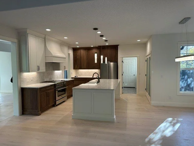 Recessed and pendant lighting design in an open-concept kitchen remodel