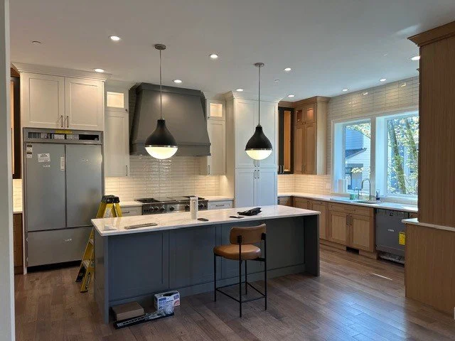 Statement pendant lights over a kitchen island in a Beaverton remodel
