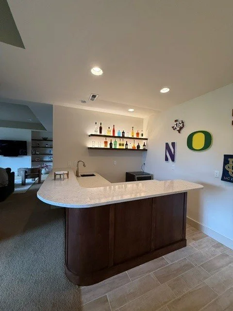 Basement bar with recessed LED lighting and lit floating shelves in Beaverton