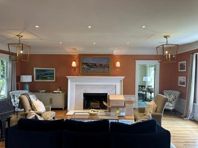 Paired brass lantern pendant lighting flanking a living room fireplace remodel