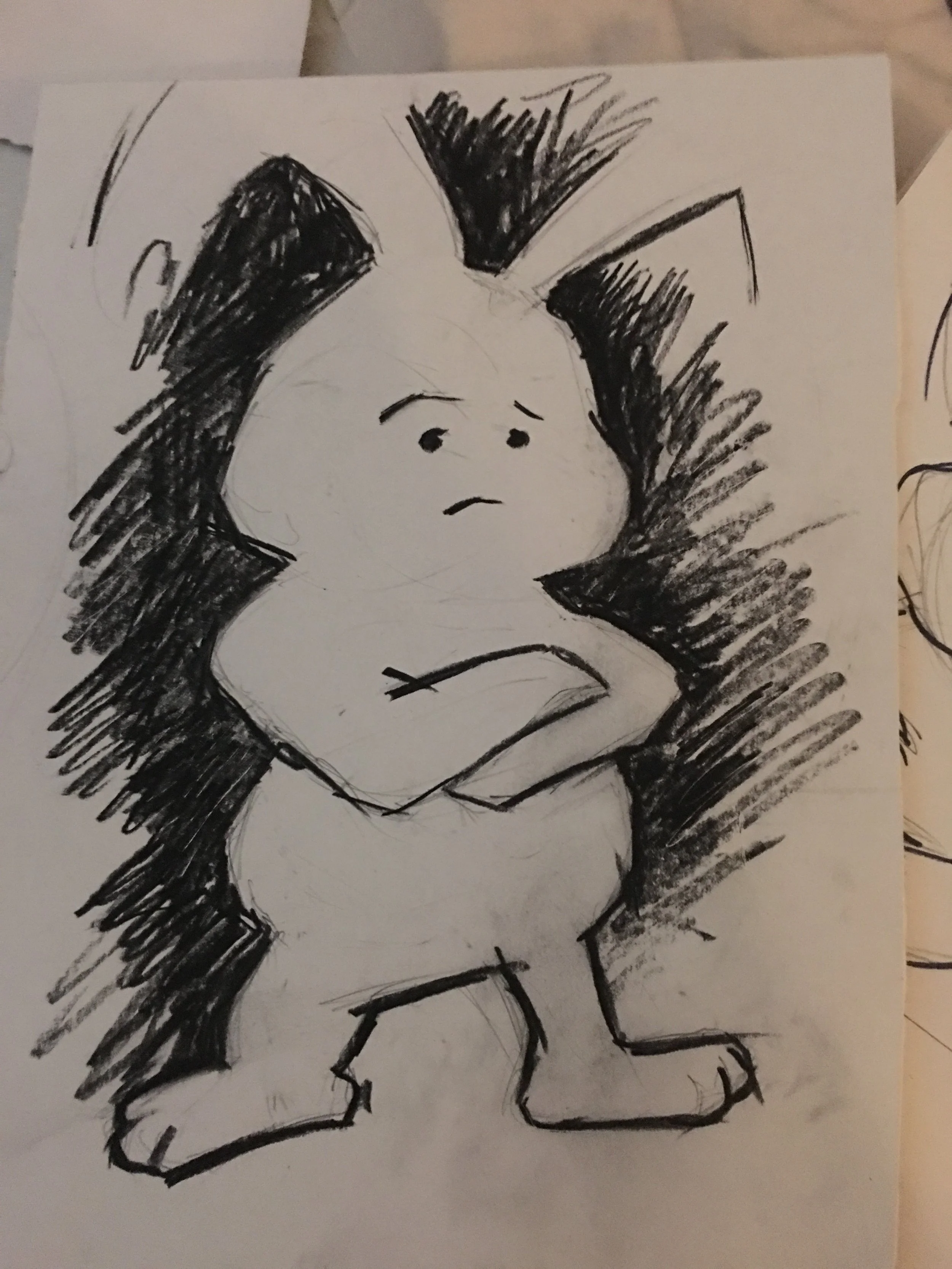 A black and white hand-drawn sketch of a cartoon character with a serious expression, big hair, and wearing a sleeveless shirt.