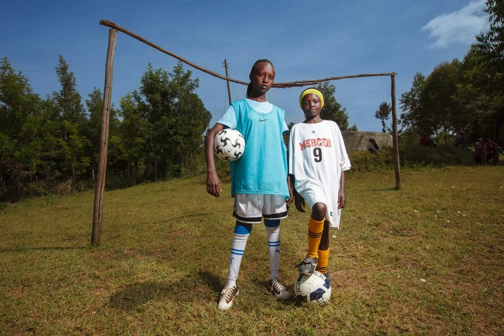 Two youth players pose for a portrait in donated gear during a soccer clinic hosted by the Fellowship of Christian Athletes (FCA) and led by US collegiate and Women's Professional Soccer (WPS) players, Wednesday, Jan. 4, 2012, near Nakuru, Kenya.