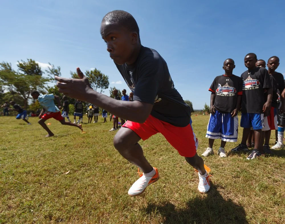 A local youth player explodes out of his starting stance during a sprint drill at a Fellowship of Christian Athletes (FCA) football clinic at Mountain Park Academy, Wednesday, Jan. 4, 2012, in Nakuru, Kenya.