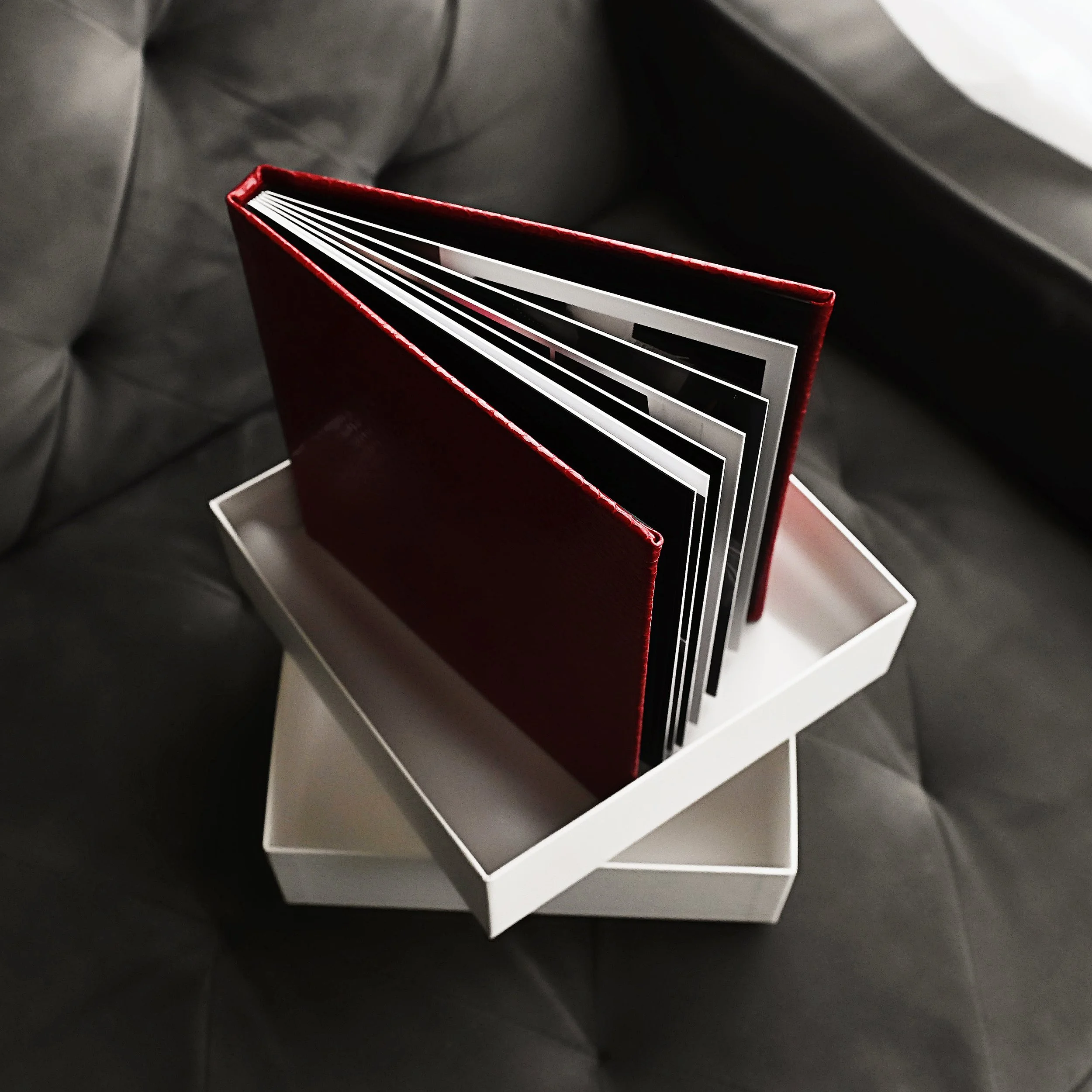 Luxury red boudoir photo album with fine art printed images displayed in a keepsake box at Blush Studio by Leslie in Shreveport Louisiana.
