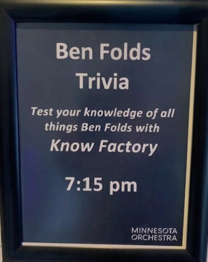 Sign advertising a Ben Folds trivia event at 7:15 pm, hosted by the Minnesota Orchestra, encouraging testing knowledge of Ben Folds and their work.