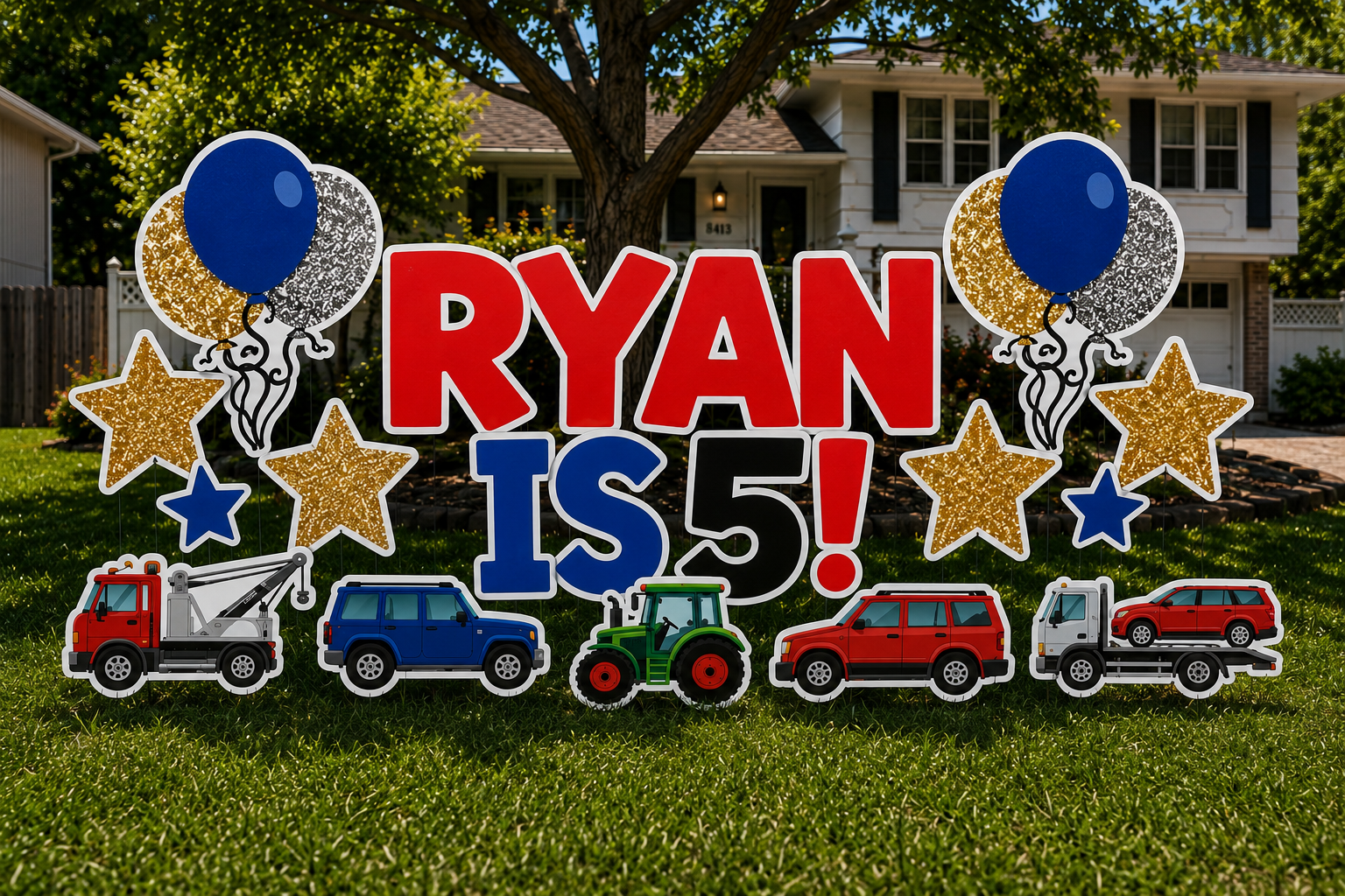 Decorative yard sign celebrating Ryan's 5th birthday with balloons, stars, and toy vehicles including a tow truck, a blue car, a green tractor, a red SUV, and a red car, set in front of a suburban house.