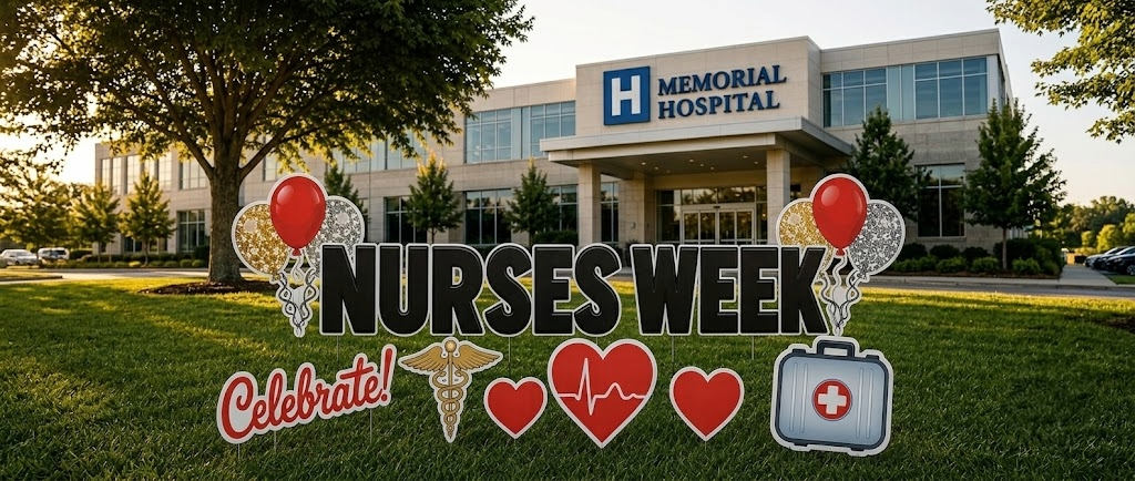 Decorative signs and balloons celebrating Nurses Week outside Memorial Hospital, with hearts, a medical caduceus, and a medical kit in front of the hospital building.