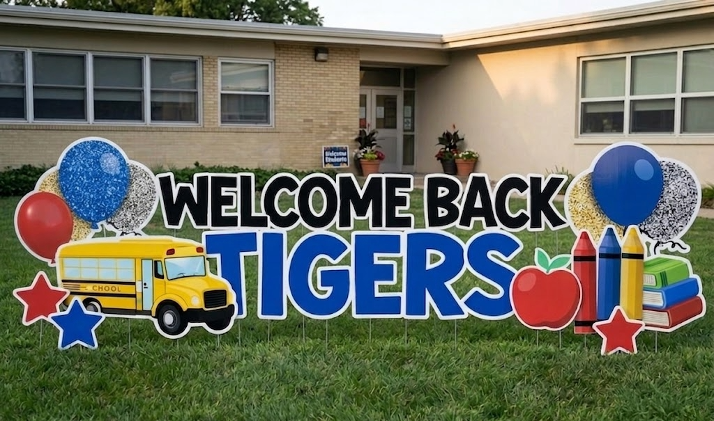Decorative welcome sign for returning students with balloons, school bus, apple, crayons, and books in front of a school building.