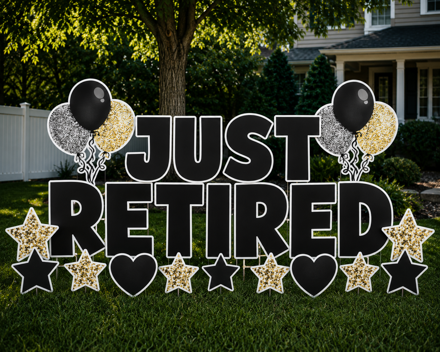 Decorative sign in a yard that reads 'Just Retired' with black, gold, and black-and-white balloons and stars.