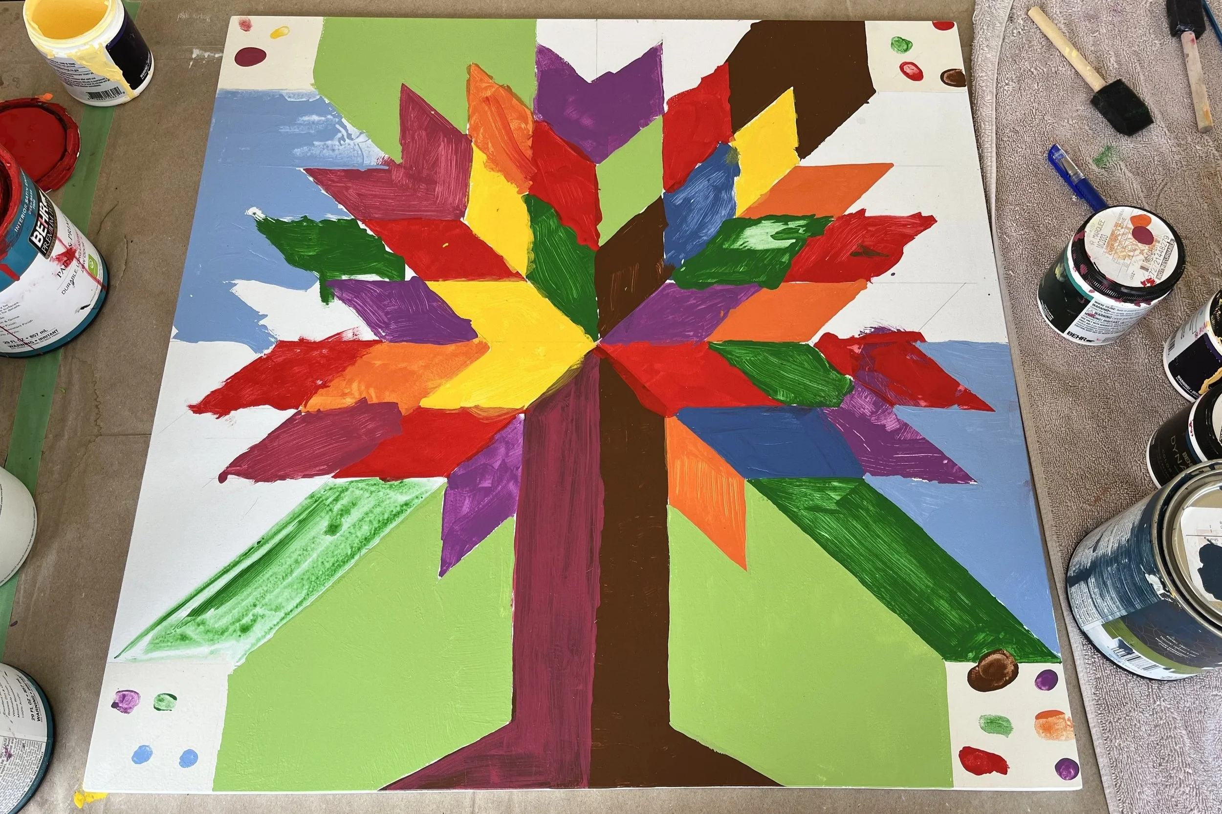 Photograph of a colorful tree barn quilt painted by the community.