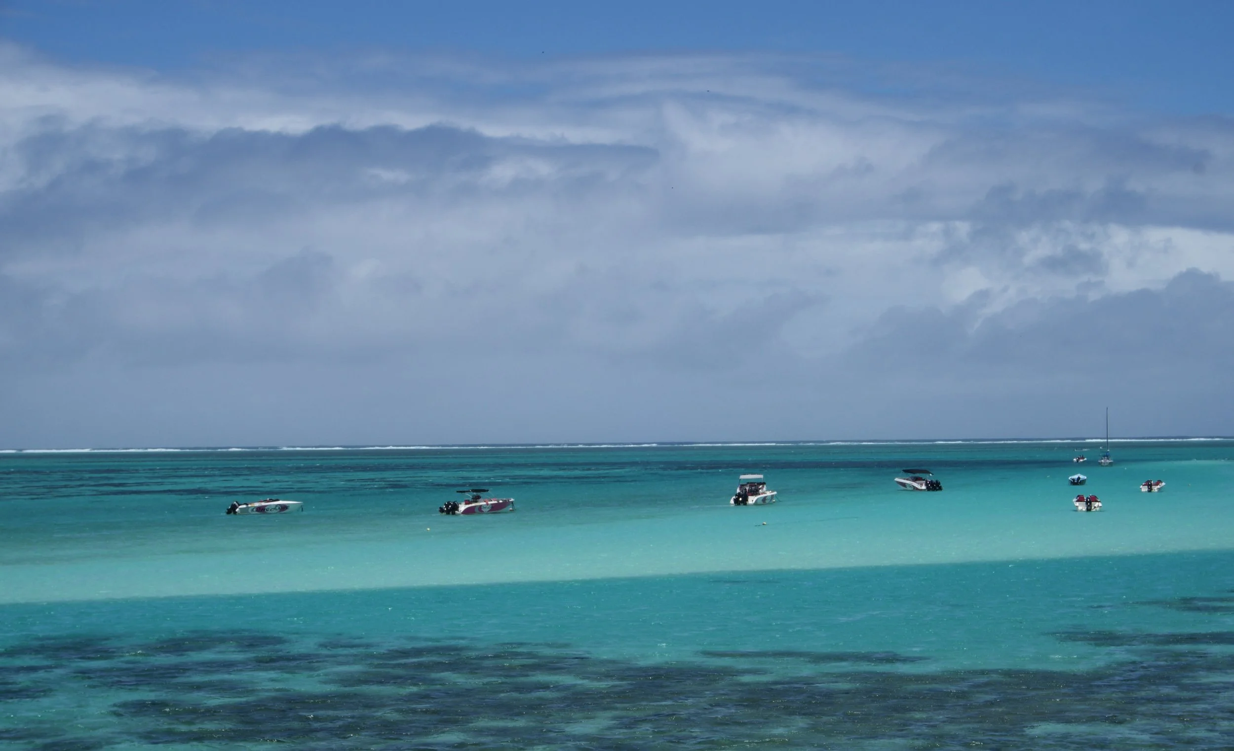 A view of the tropical lagoon surrounding eastern Mauritius,  with heavy waves breaking against the outer reefs as a cyclone approaches the island.