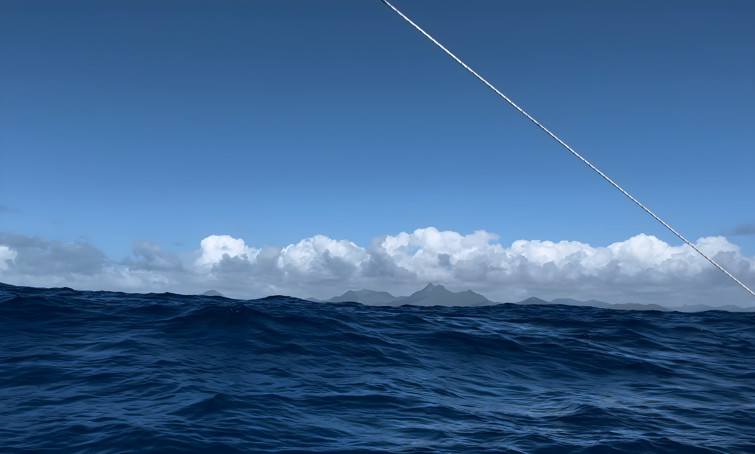 Open ocean with dark blue waves and a distant mountainous island under a clear blue sky. A diagonal line, possibly part of a boat's rigging or mast, crosses the image.
