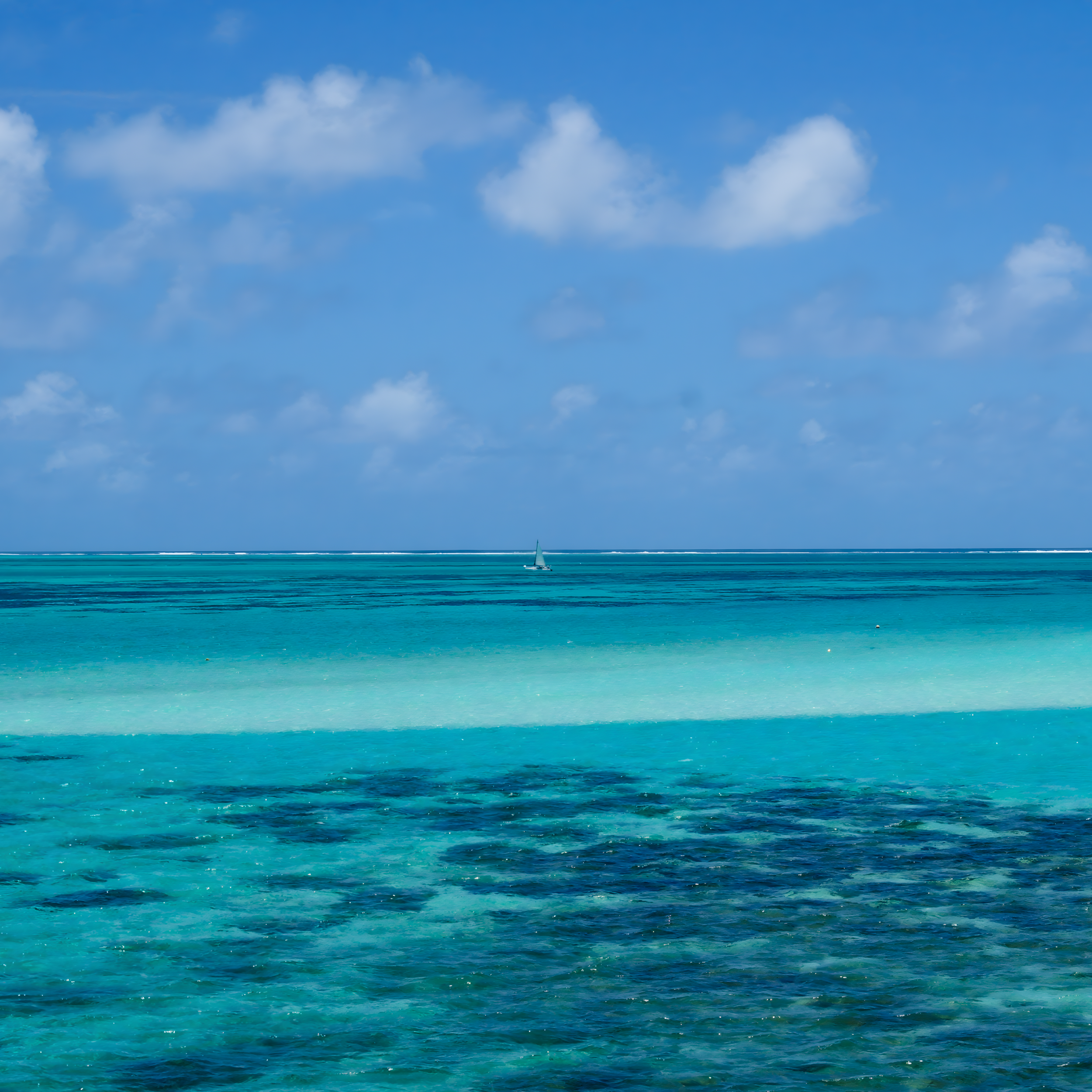 The tropical lagoon encircling eastern Mauritius serves as the setting for the Open Ocean Quest. The outer reefs are visible in the distance, and beyond that, the vastness of the Indian Ocean.
