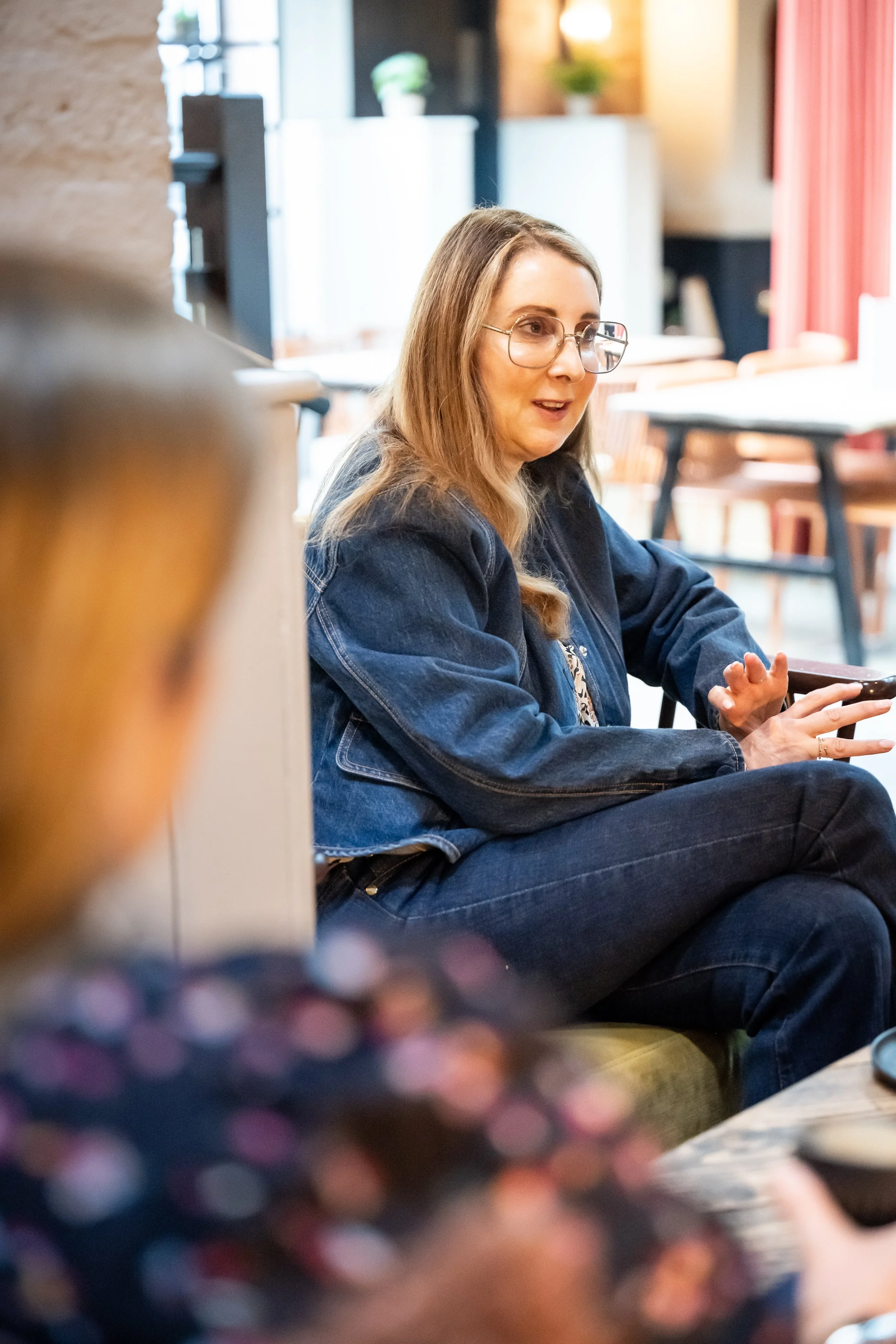 Sam Remer, denim-first personal stylist, wearing dark blue denim jeans during a styling session.