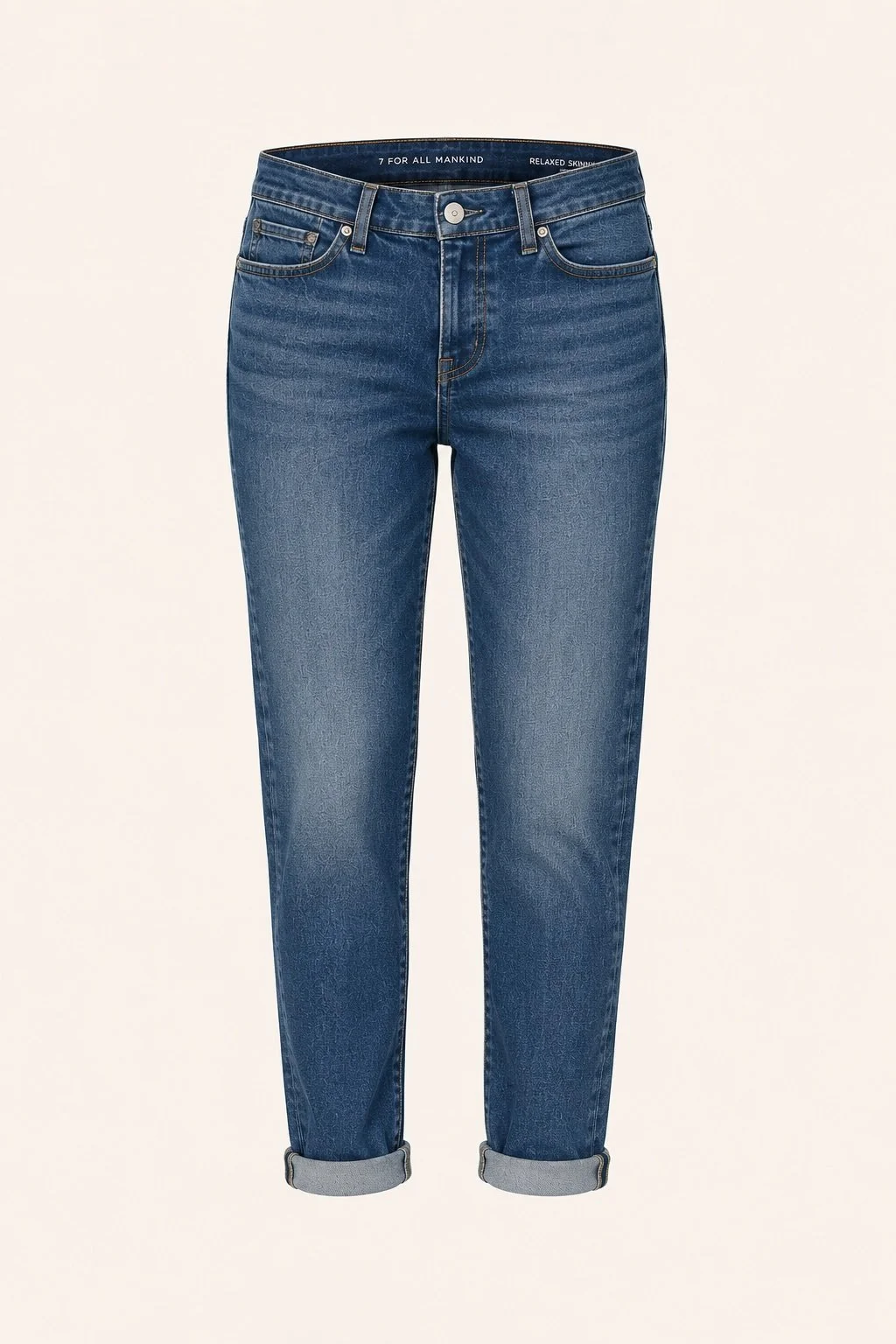A pair of Girlfriend blue denim jeans with rolled cuffs, displayed against a plain background.