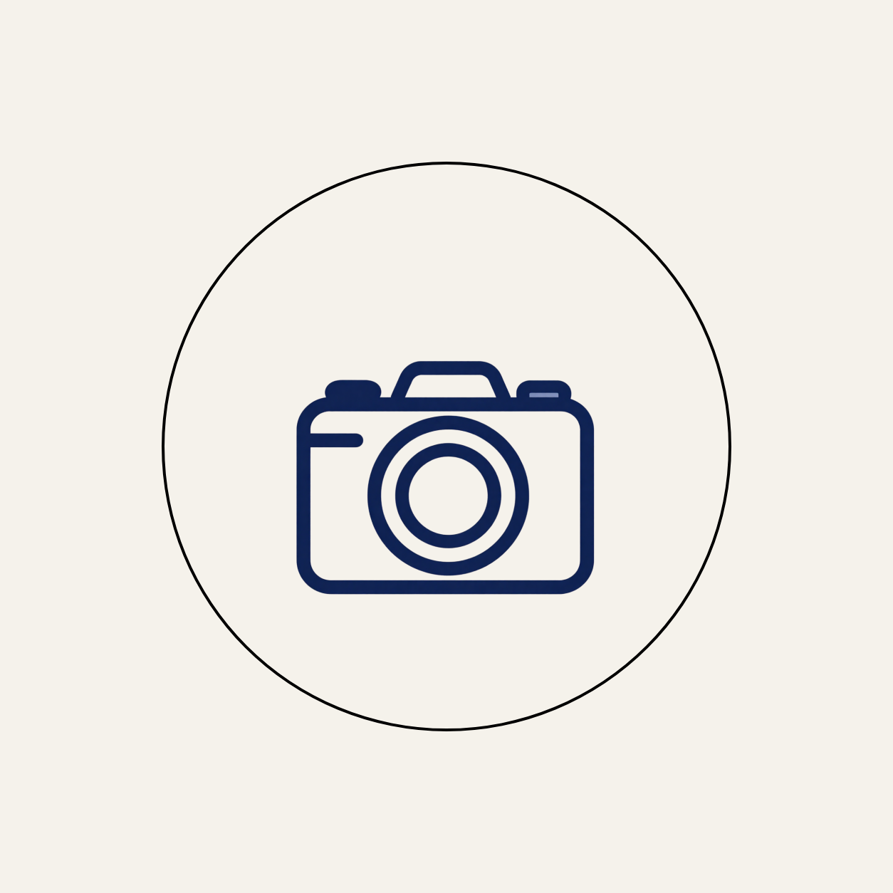 Icon of a camera with a circular lens, outlined in dark blue, centered within a circle.