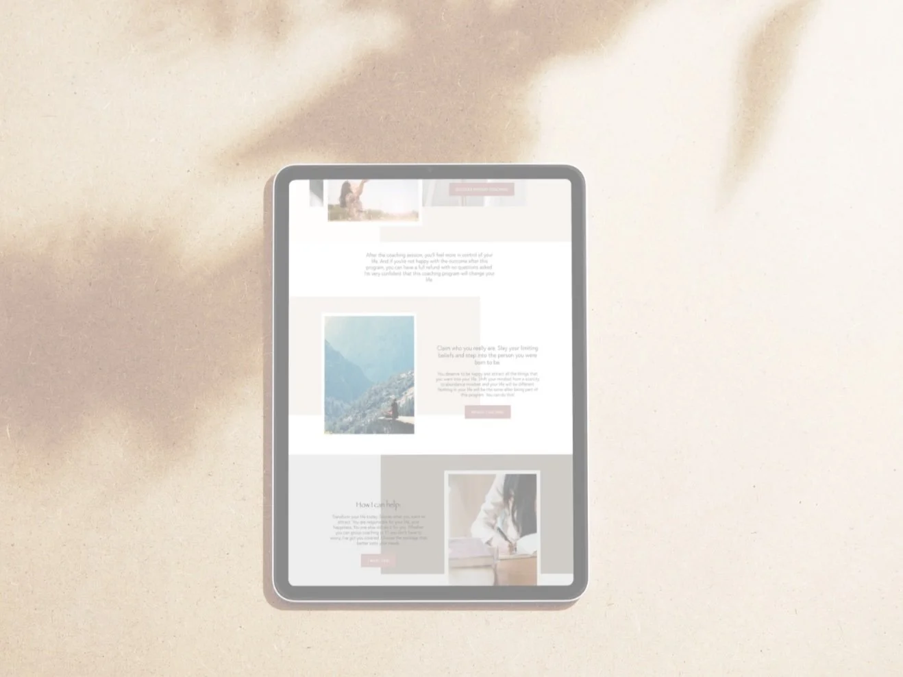 A tablet displaying a website with images of people and outdoor scenery, placed on a textured surface with a blurred abstract background.