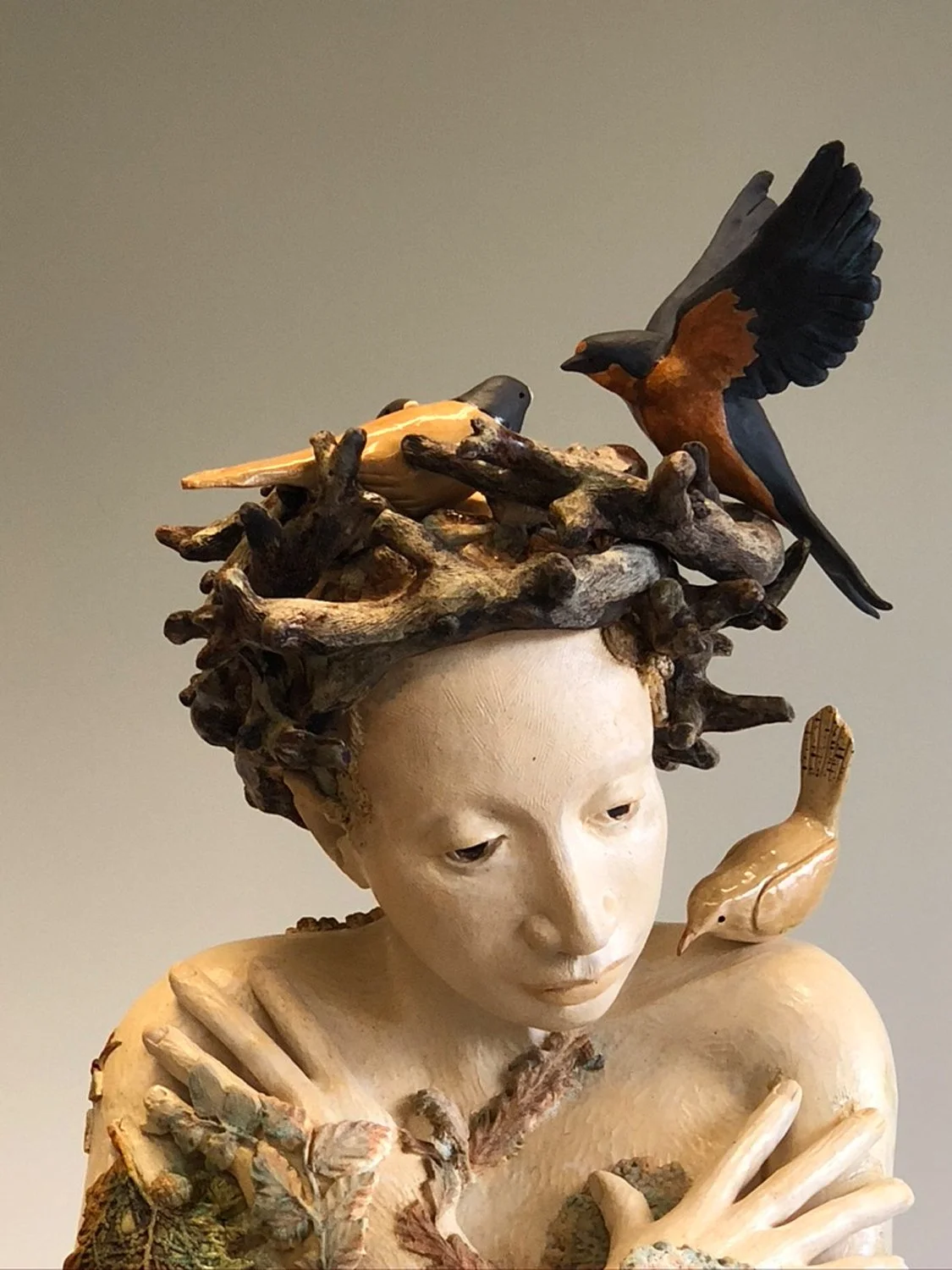Sarika (Bird Song) by PNW sculptor Maria Wickwire wears a ceramic nest on her head with birds coming and going.
