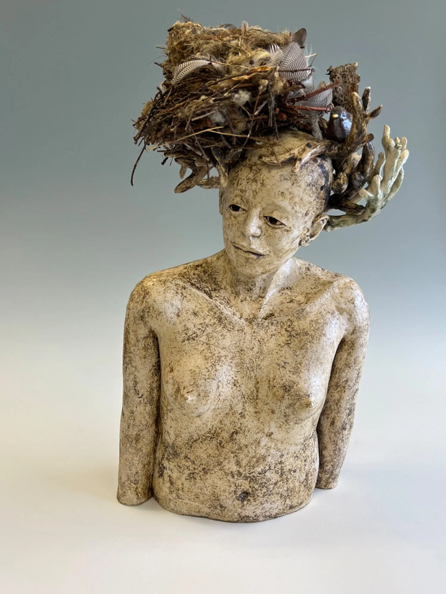 Poetic psychological figurative sculpture with bird imagery, contemporary ceramic artwork about emotional transformation and inner life.