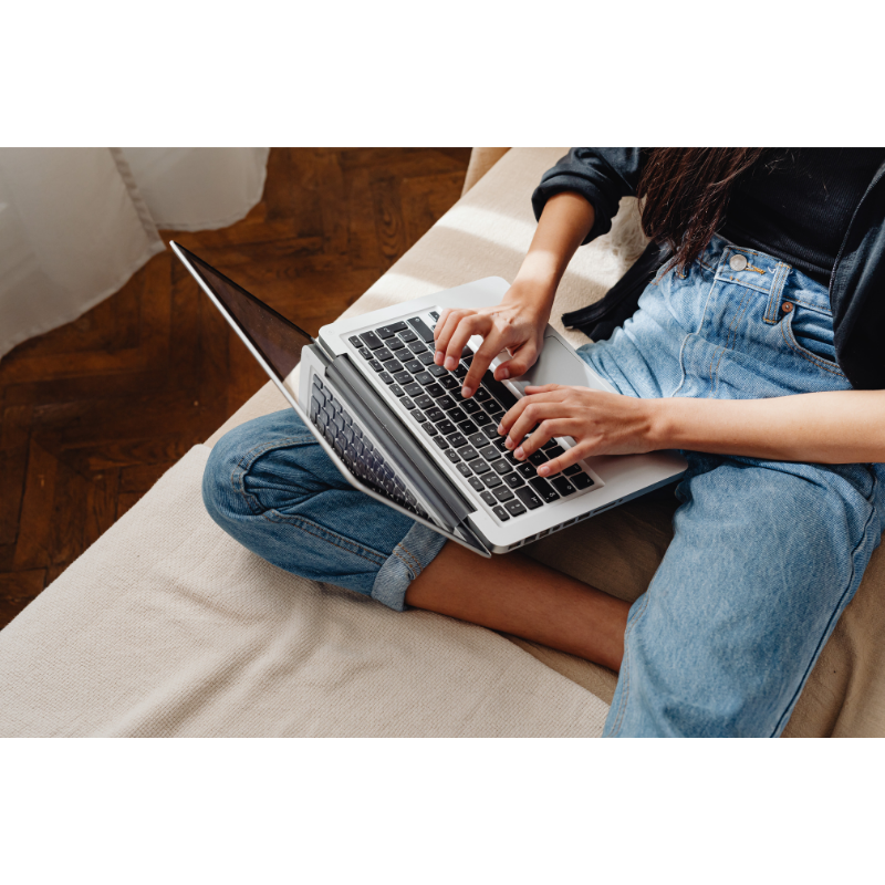 sitting with laptop on lap typing