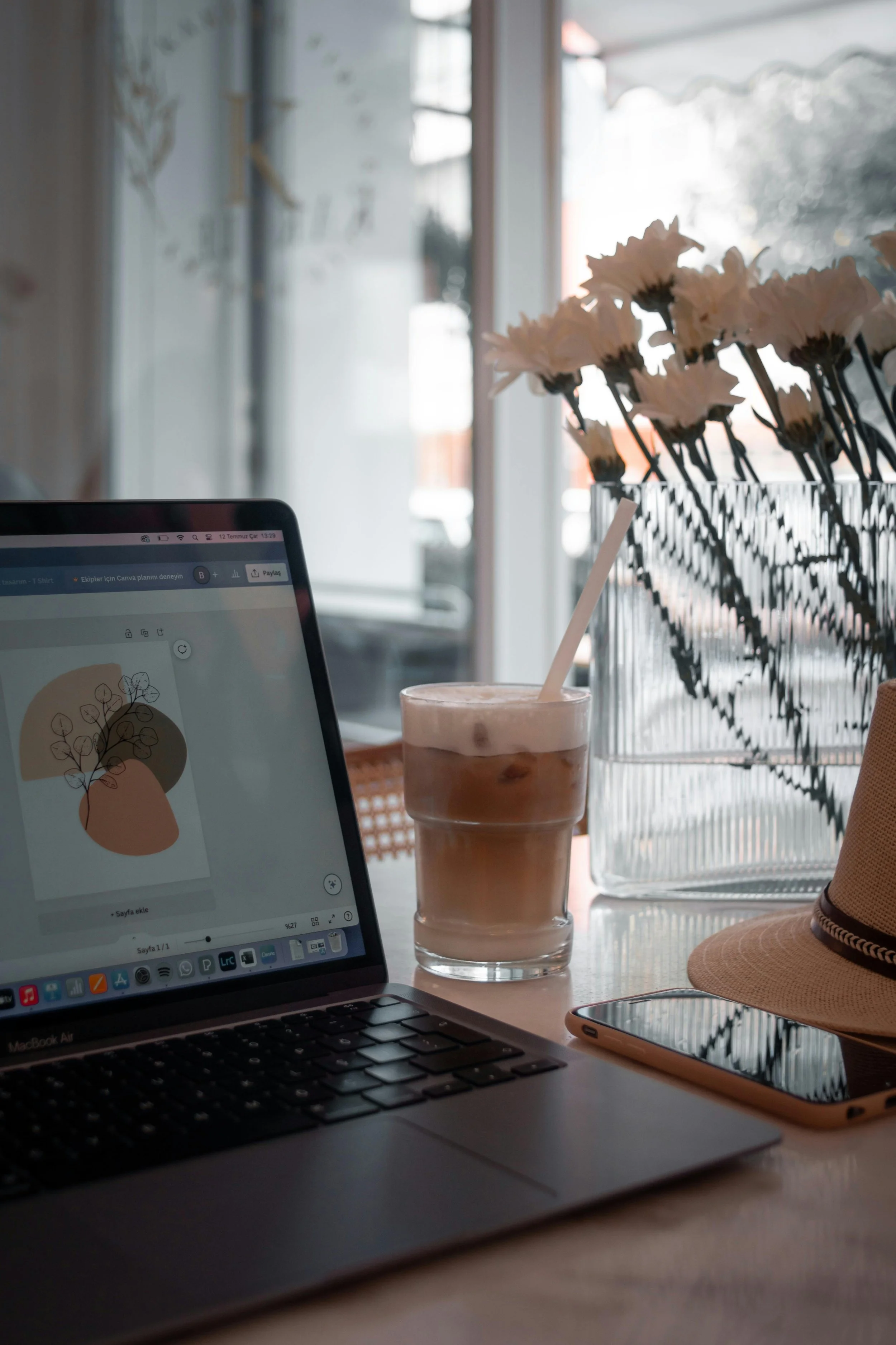laptop on desk with flowers