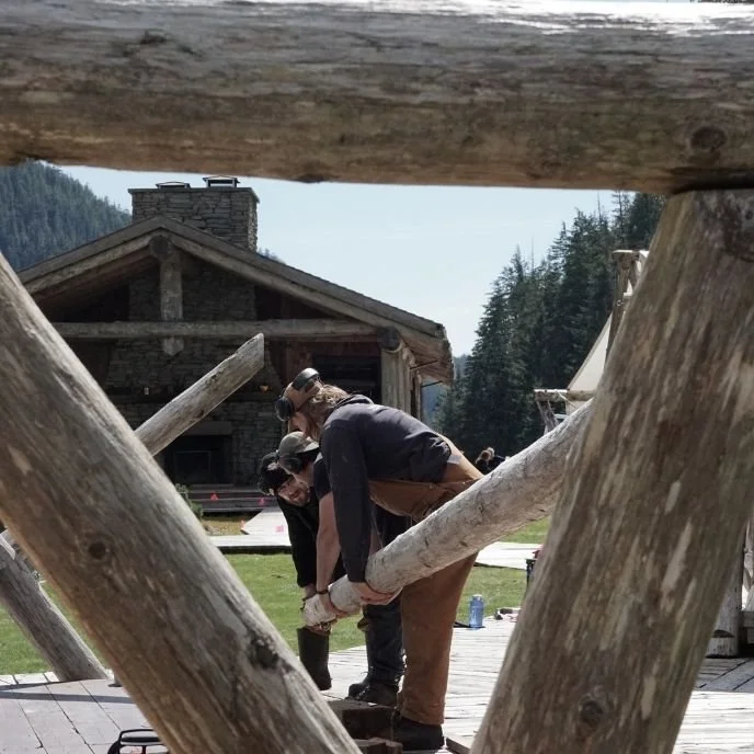 mtn side crew working on glamping tent poles on British Columbia at clayoquot wilderness lodge