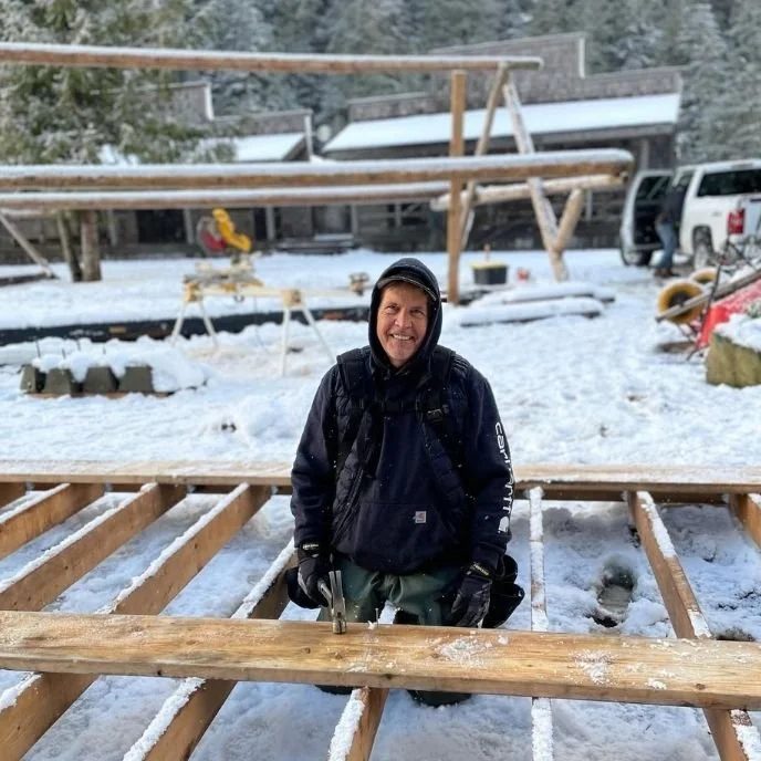 Andrew stokes owner and operator of mtn side working on exterior project in the winter time at a remote wilderness lodge