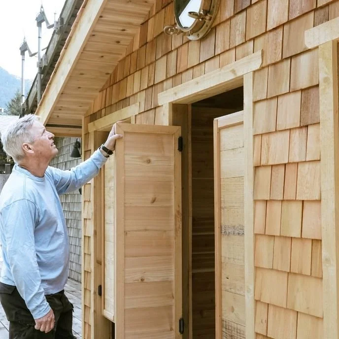 Andrew stokes appreciating the wood work of the crew on revamping and rebuilding and exterior changing room for guests at an remote wilderness lodge