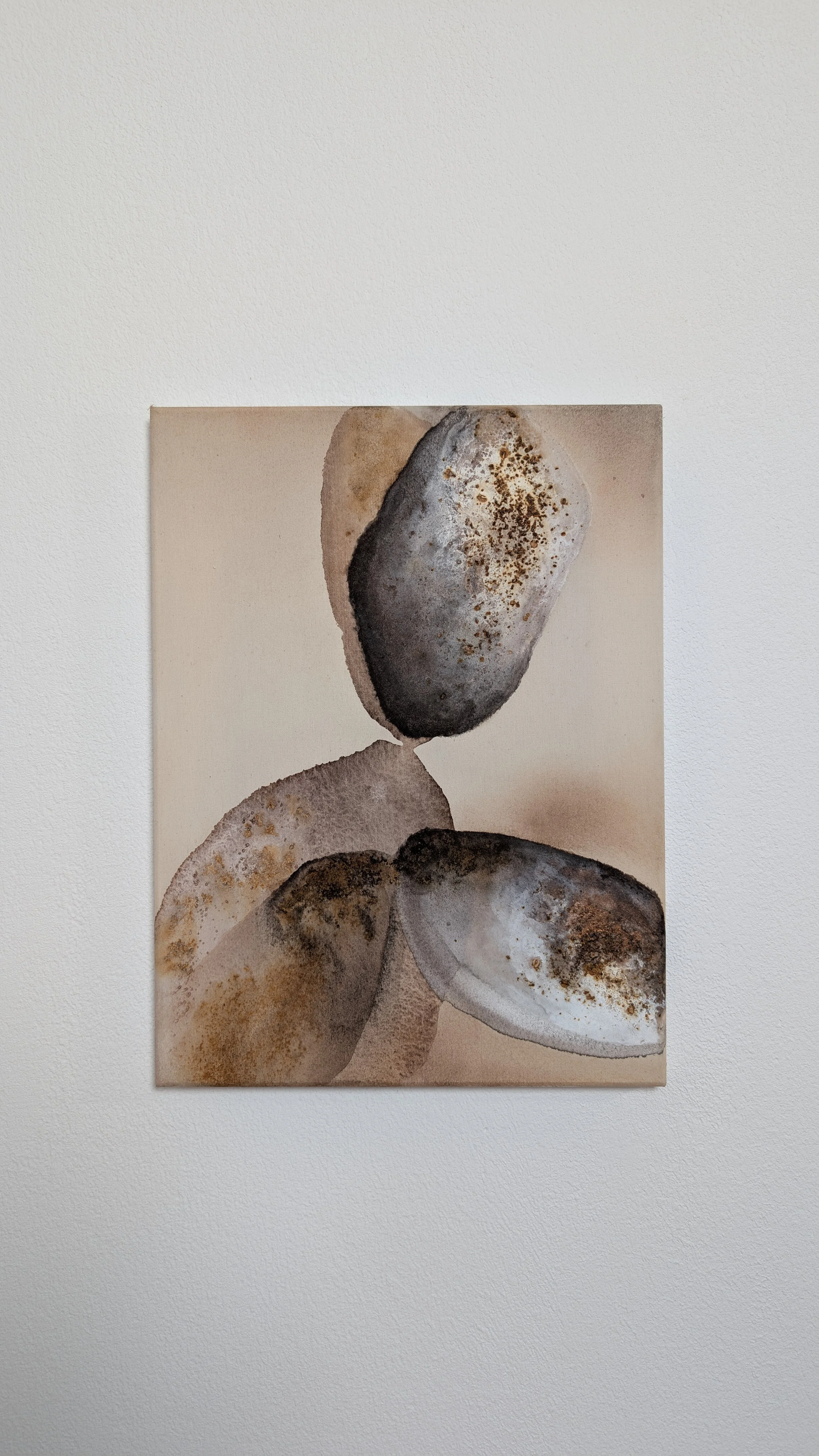 A watercolor painting of smooth stones with earthy tones, arranged in an abstract composition.