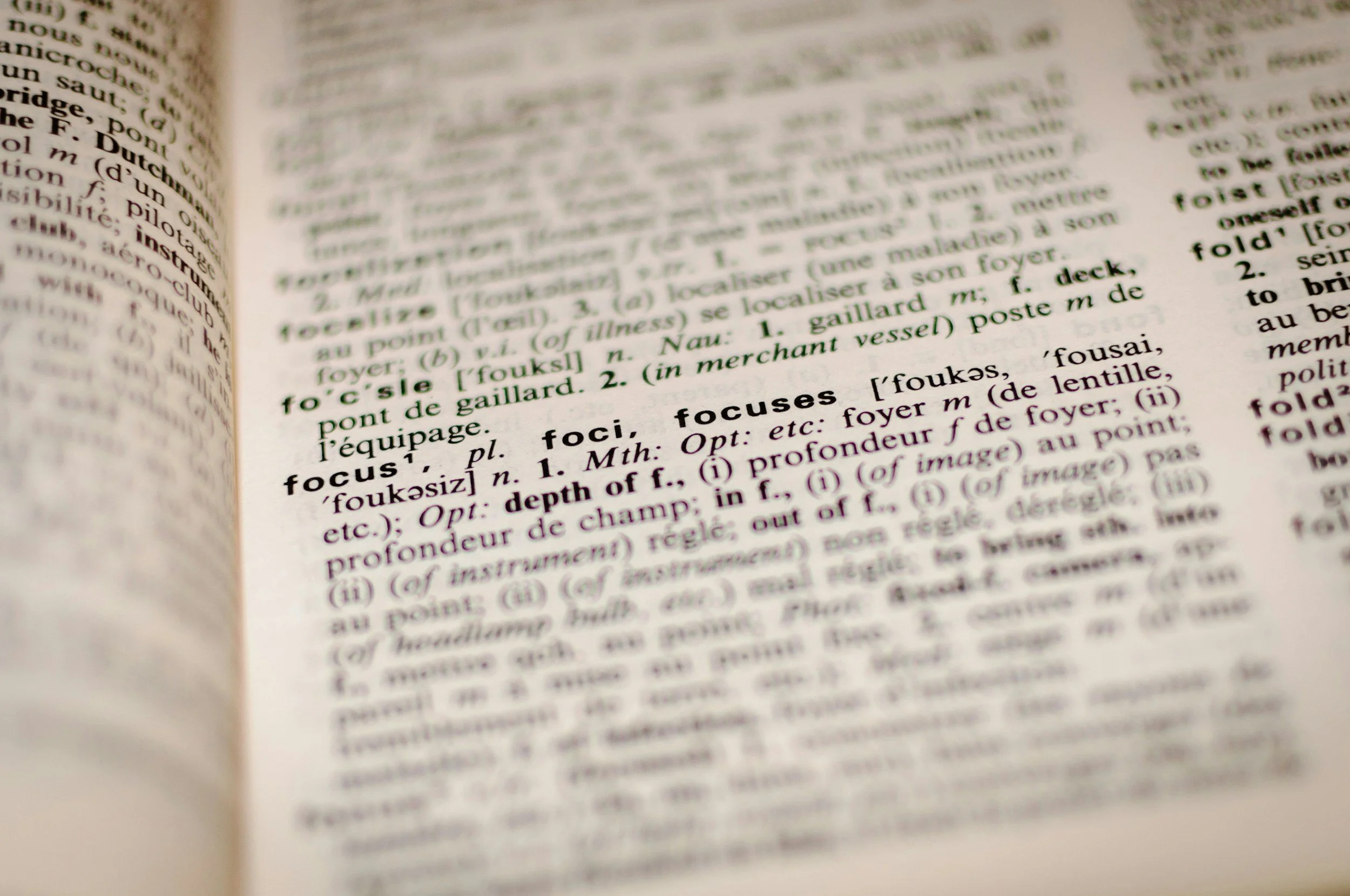 Close-up of a dictionary page showing the word 'focus' and its definition.