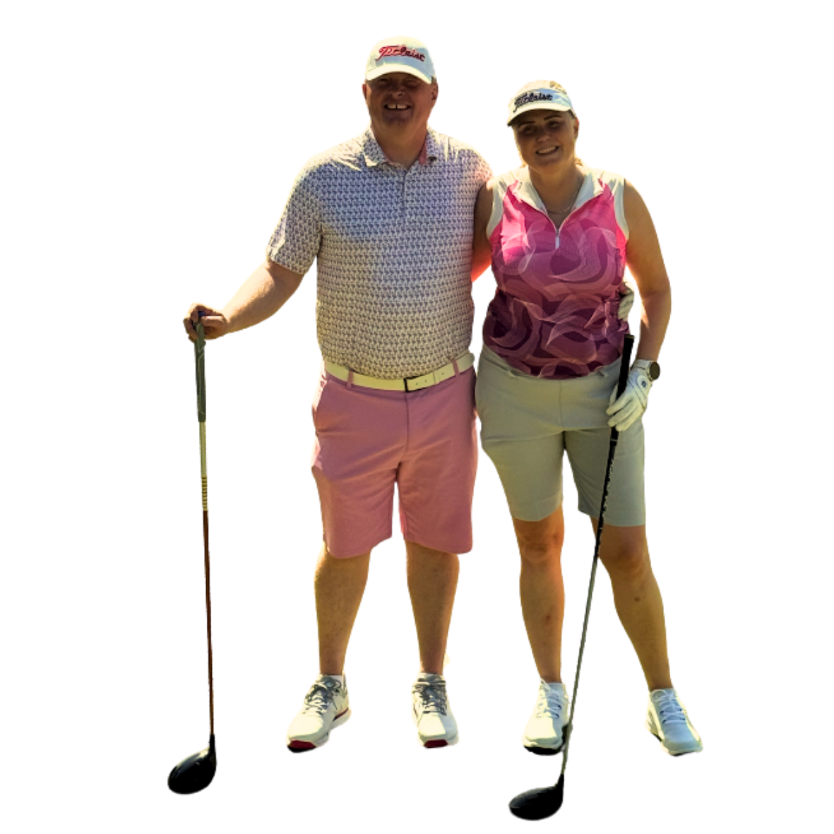 A man and woman dressed in golf attire, posing with golf clubs on a golf course during daytime.