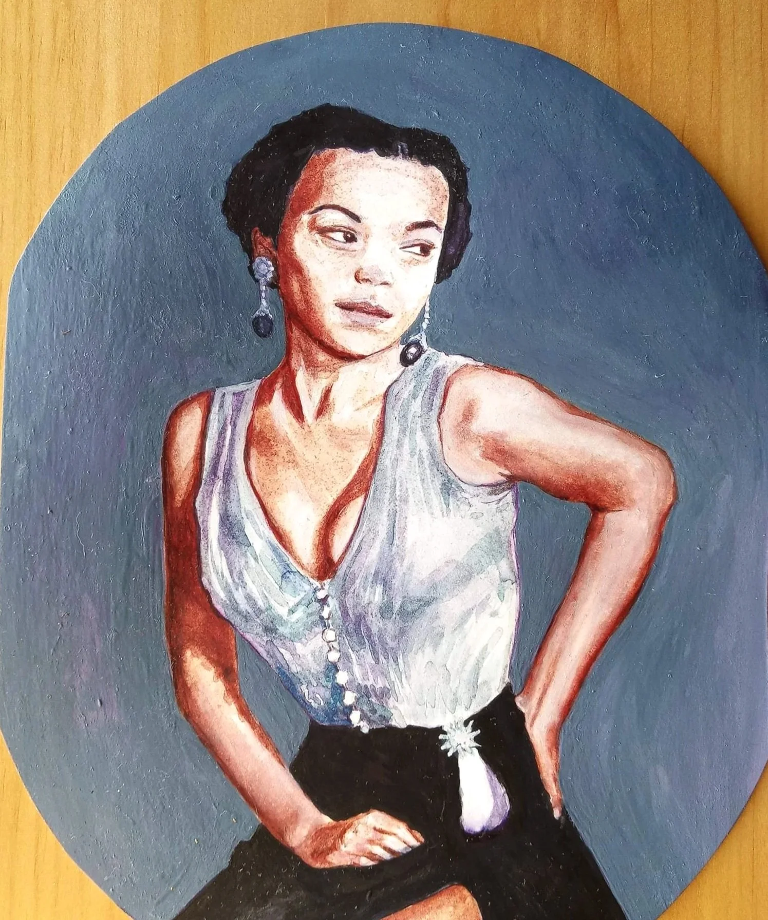 Watercolor Portrait study of Eartha Kitt sitting with grey purple background.