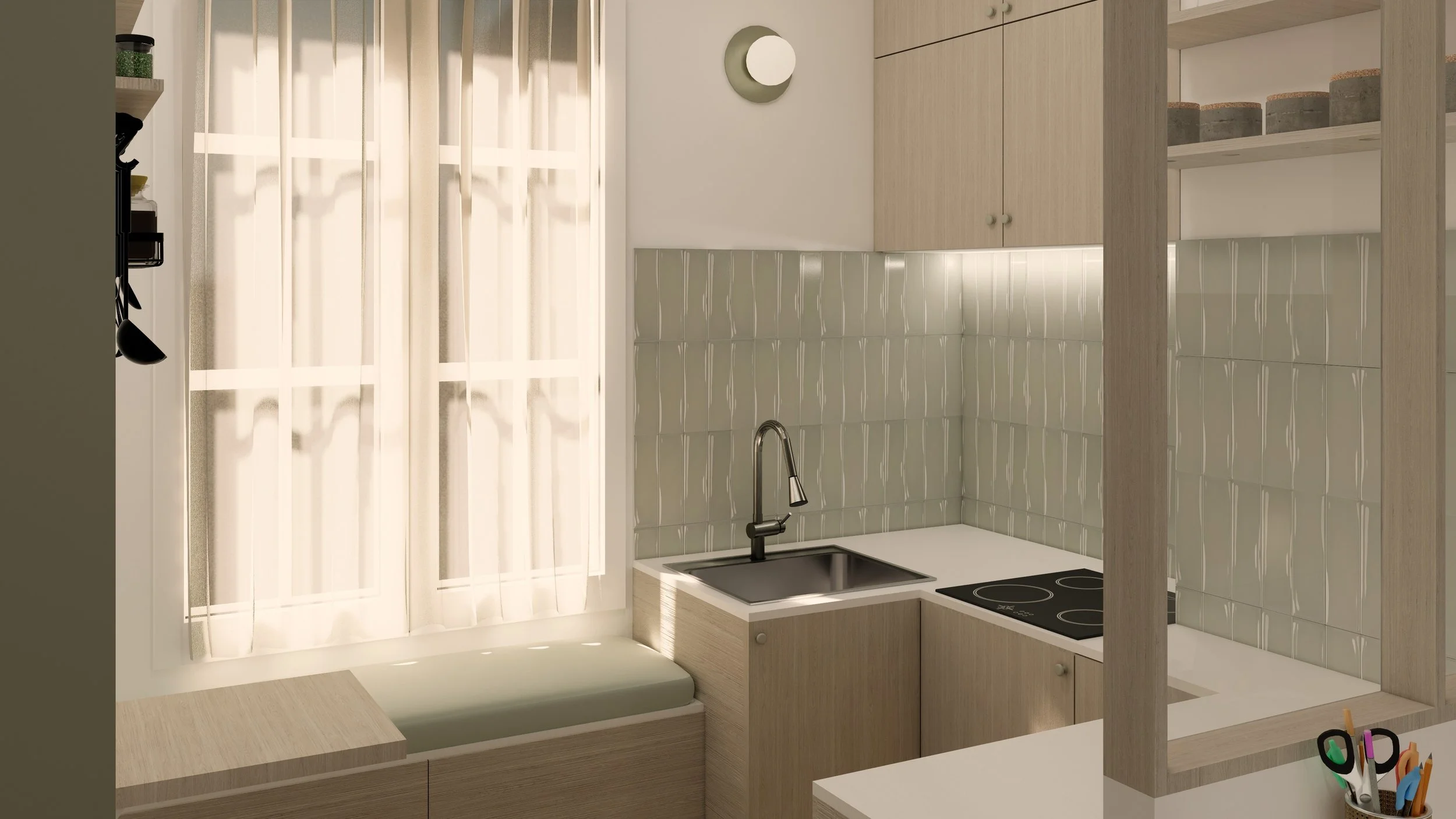 Une cuisine moderne avec unités en bois clair, un évier, une plaque de cuisson électrique, des carreaux de mur gris et des rideaux blancs laissant passer la lumière naturelle.