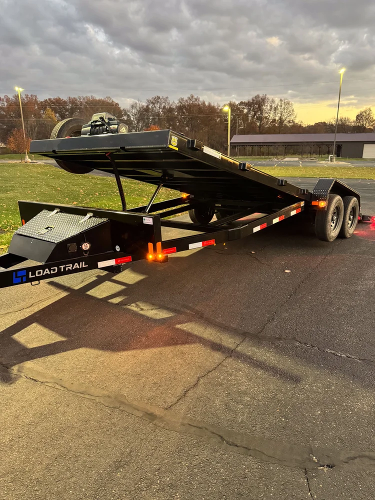 Load Trail car hauler with its hydraulic deck tilted for loading.