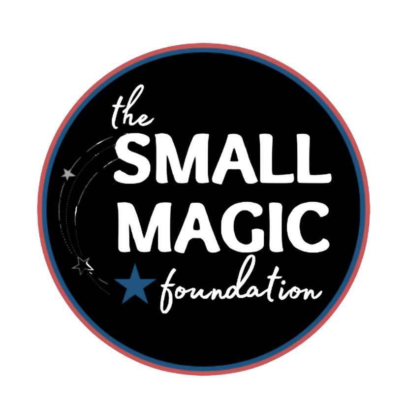 Logo of the Small Magic Foundation with white text on a black circular background, decorated with small stars and a blue star, and a red border.