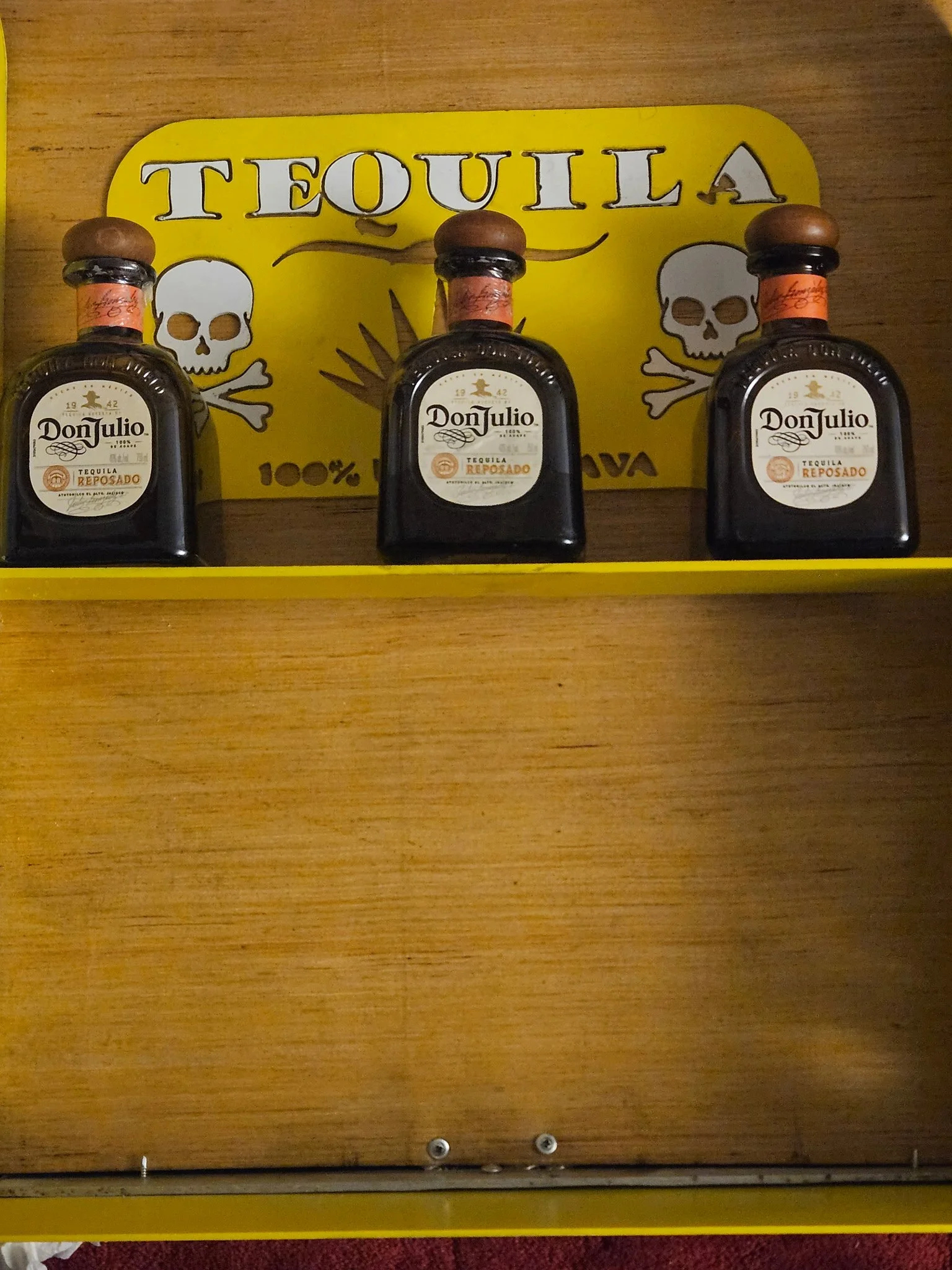 Custom CNC plasma-cut "Tequila" steel bar sign. Features a vibrant, heavy-duty yellow powder-coated finish with precision-cut artistic skull and agave details, integrated with custom metal shelving to create the ultimate statement piece for home bars
