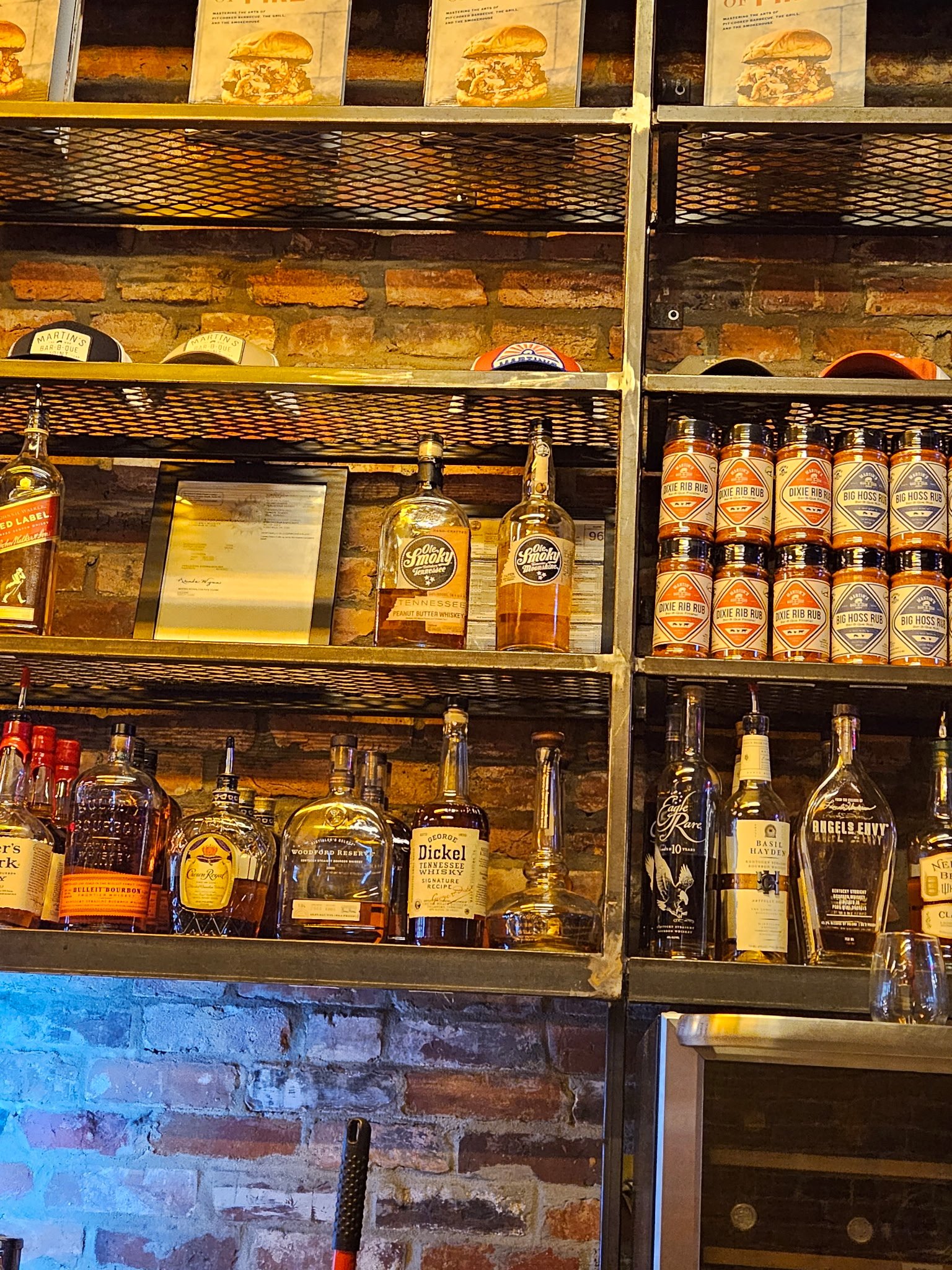 Custom commercial backbar display shelving. Detail shot showcasing the precision-aligned steel framework and integrated ambient accent lighting, custom-built for high-end restaurant and hospitality venues.