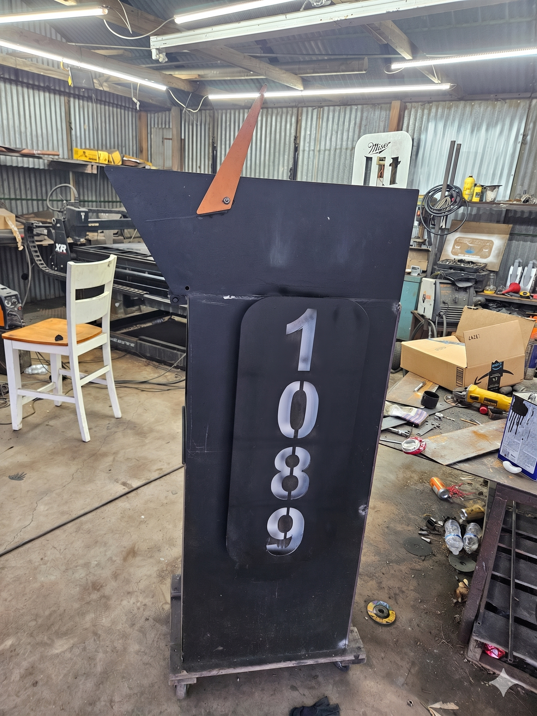 Custom modern heavy-duty steel mailbox post. Precision-built from thick-gauge structural steel, featuring a sleek architectural profile, integrated mail receptacle, and custom CNC plasma-cut vertical house numbers.