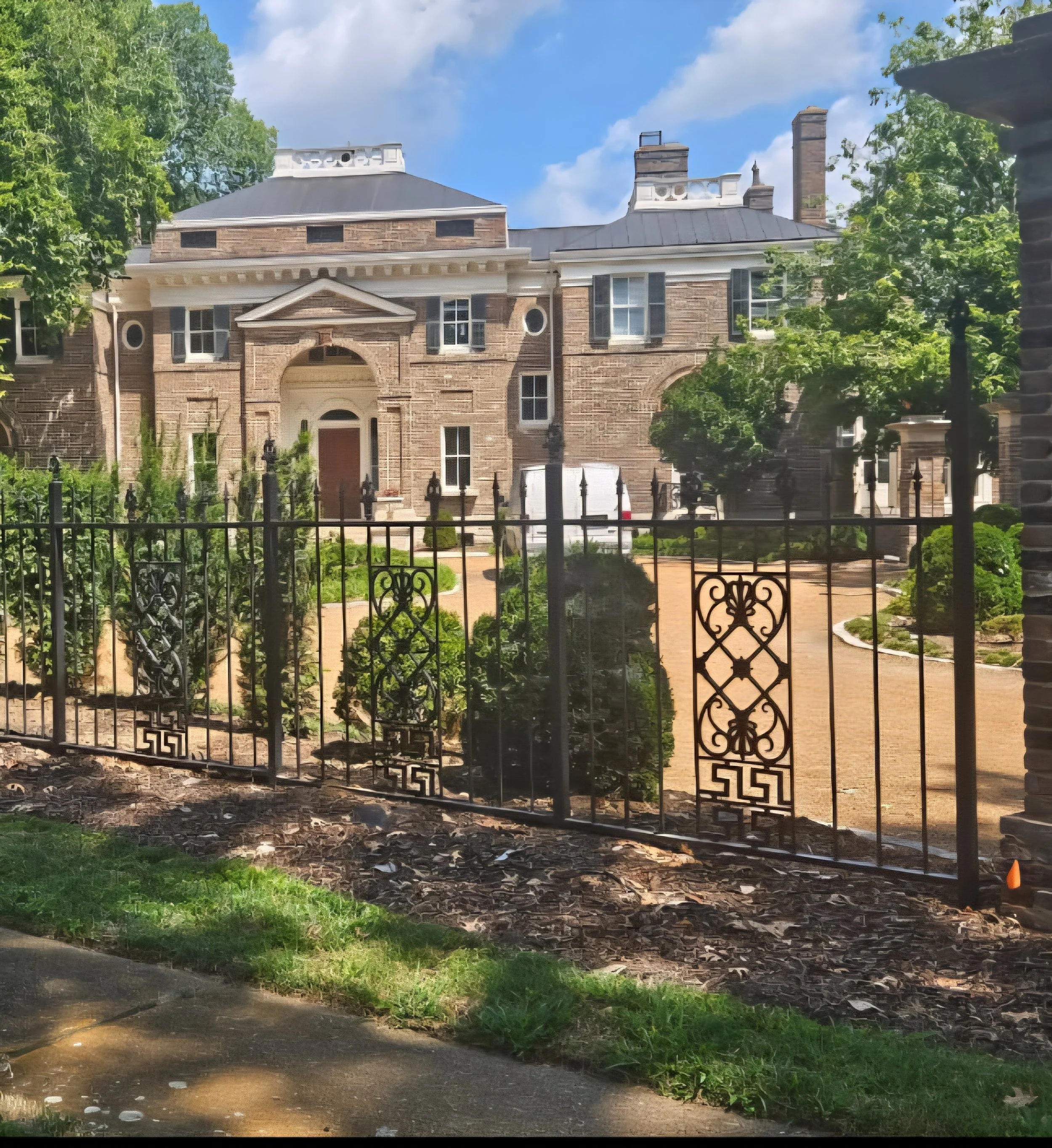 Custom ornamental steel perimeter estate fencing. Features elegant decorative pickets and robust structural paneling, precision-crafted to complement high-end traditional masonry while providing secure, long-lasting property borders.