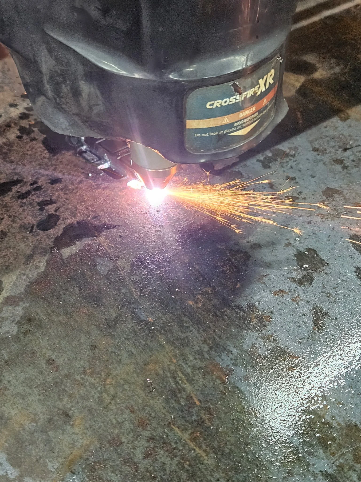 Precision CNC plasma cutting in action. High-speed, automated metal fabrication cutting custom designs and intricate patterns out of heavy steel plate with flawless accuracy.