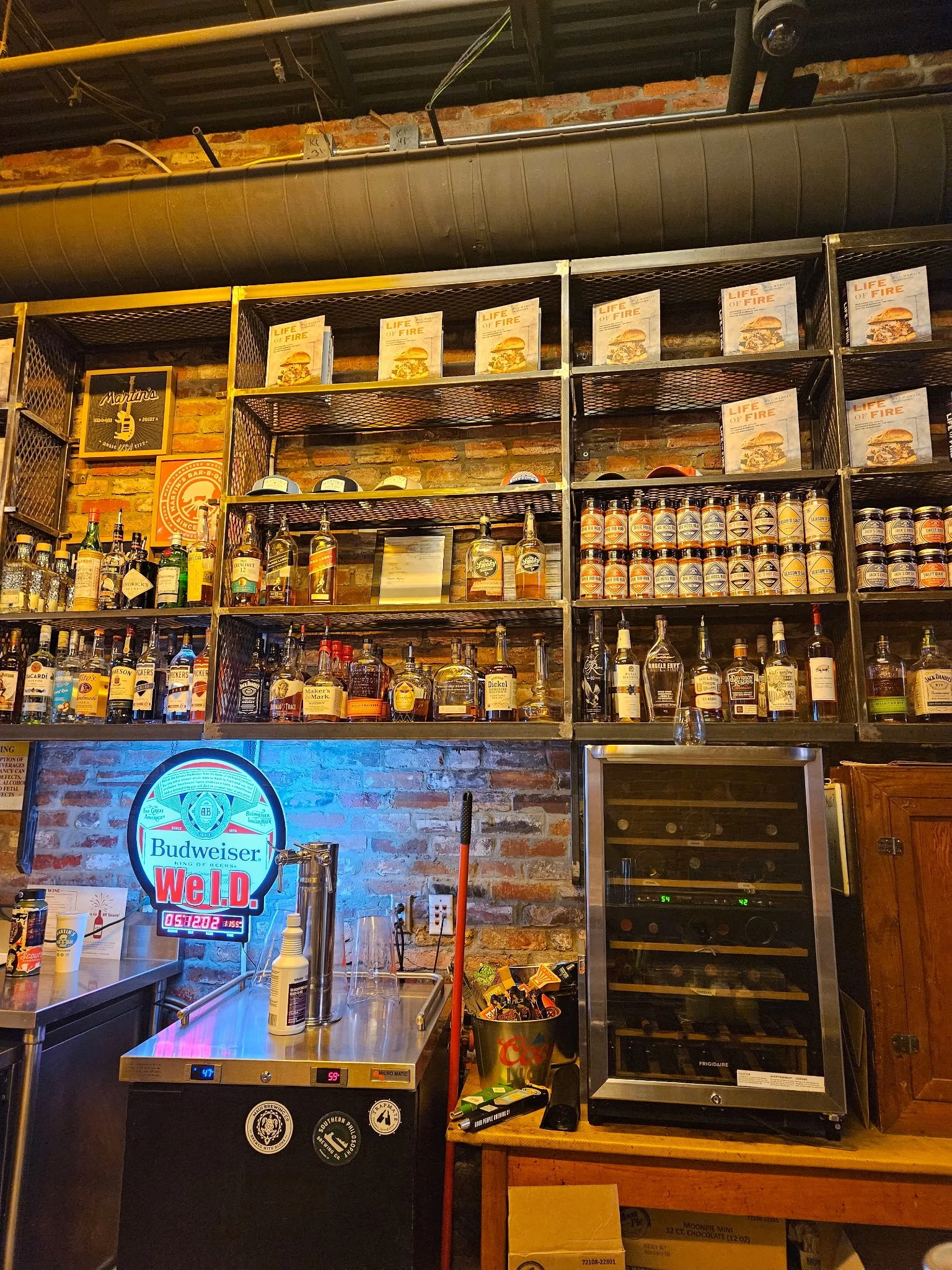 Custom commercial architectural backbar shelving system. Precision-engineered steel framing designed for high-capacity display, combining industrial strength with sleek modern aesthetics to elevate premium hospitality and retail spaces.