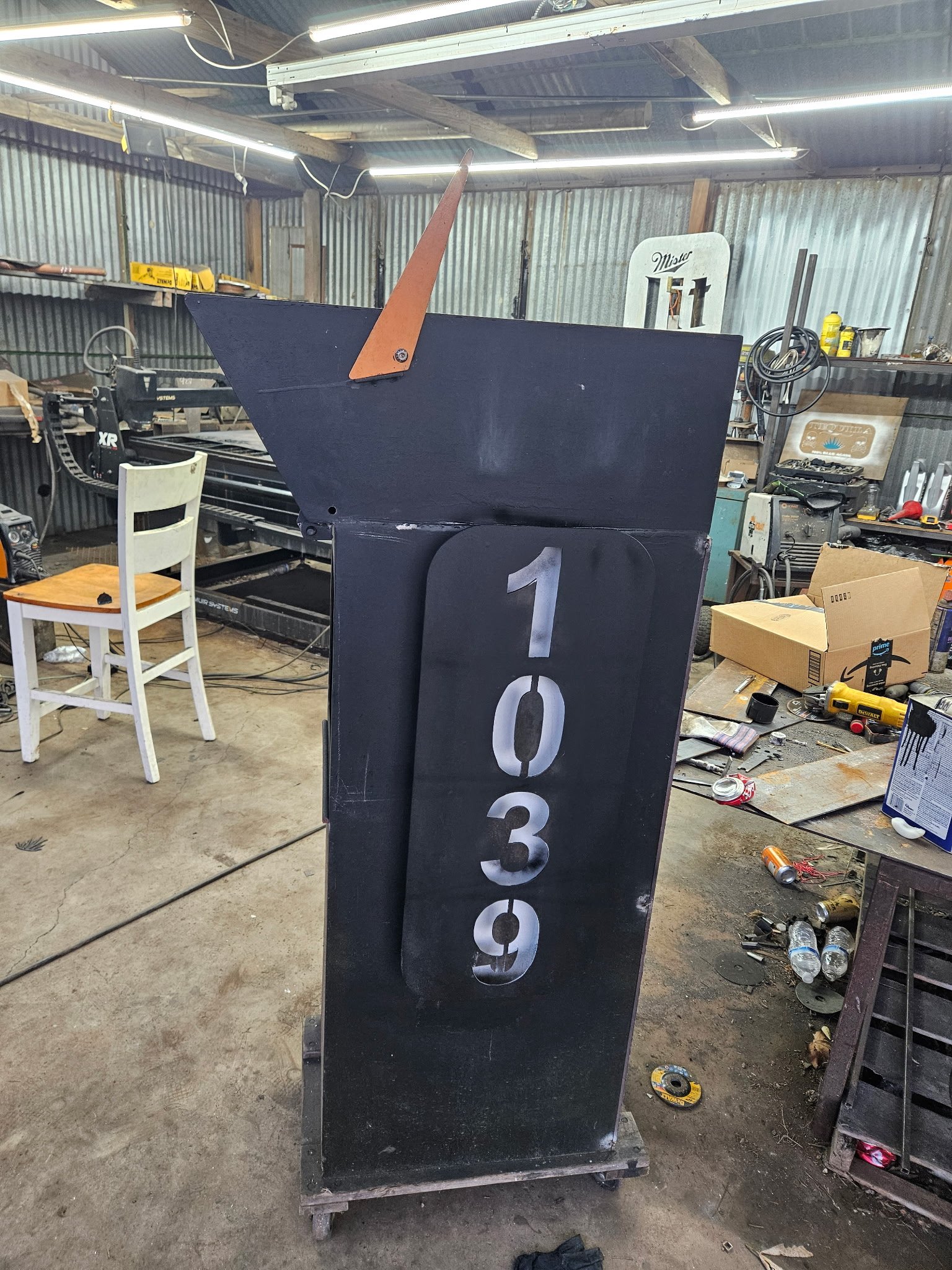 Custom modern heavy-duty steel mailbox post. Precision-built from thick-gauge structural steel, featuring a sleek architectural profile, integrated mail receptacle, and custom CNC plasma-cut vertical house numbers.