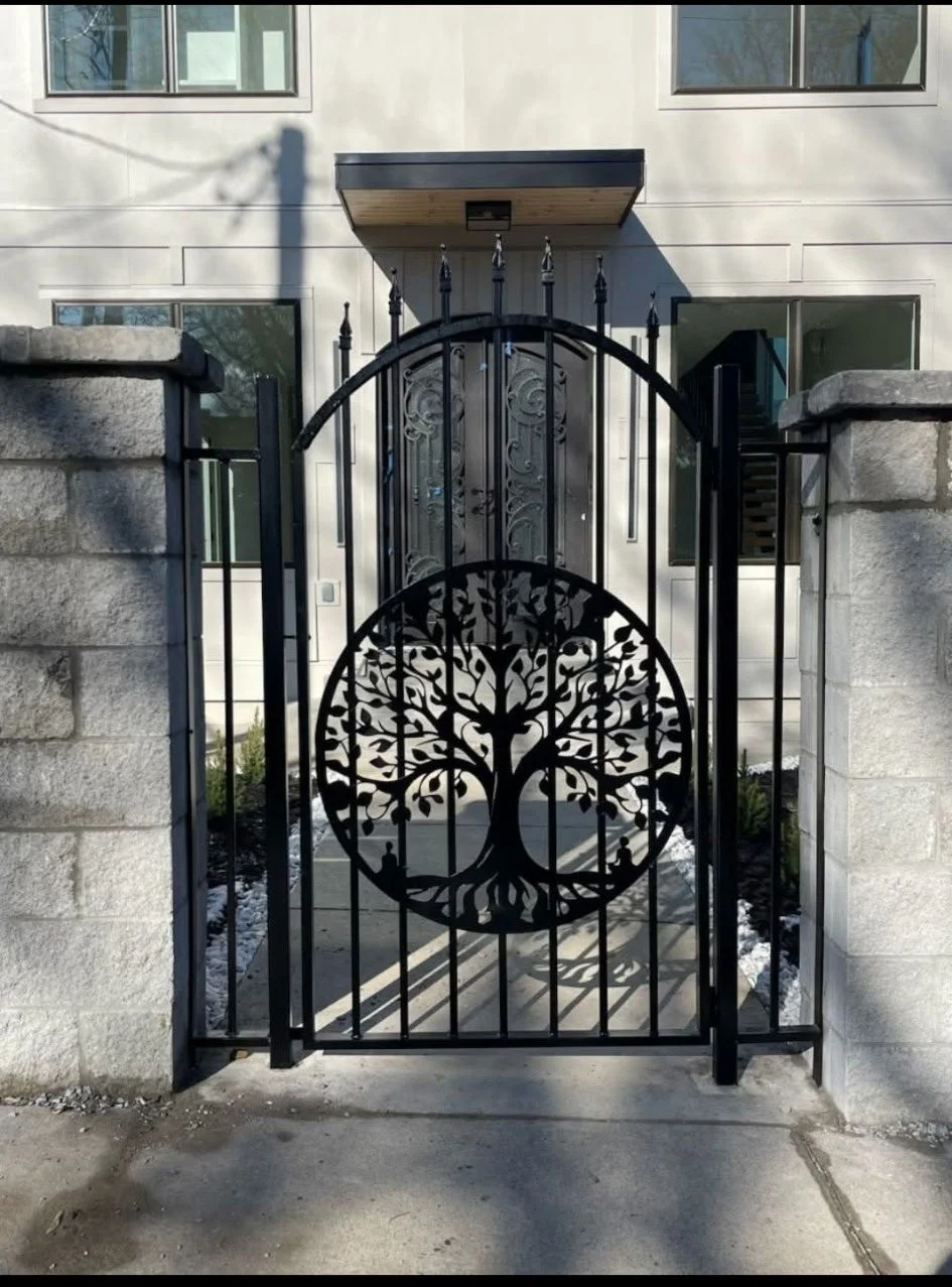 Custom-fabricated modern steel driveway gate featuring a detailed geometric tree-of-life centerpiece. Built with a heavy-duty structural frame and finished with a durable coating to deliver a unique blend of security, artistry, and lasting curb appea